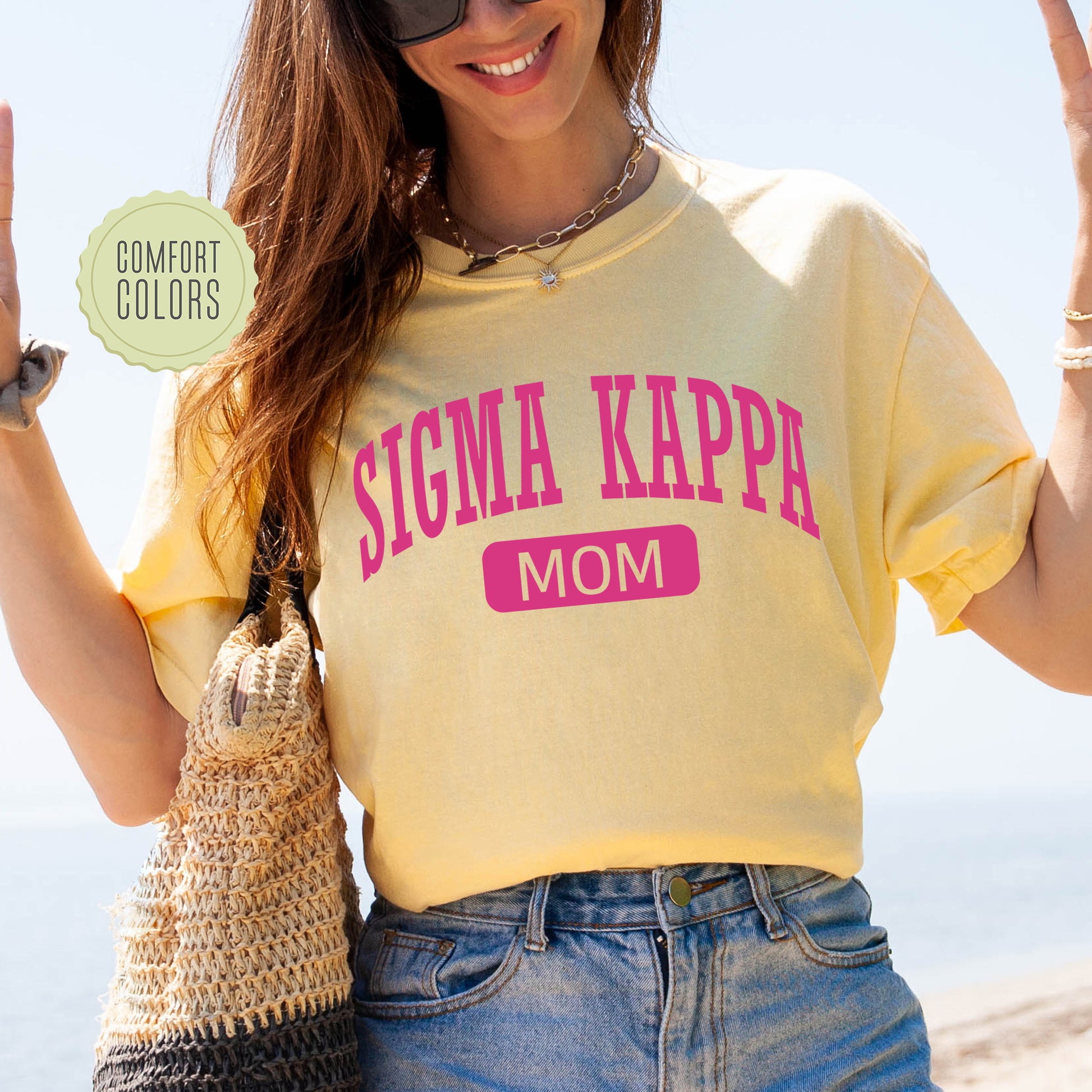 a woman in a yellow shirt holding up a peace sign