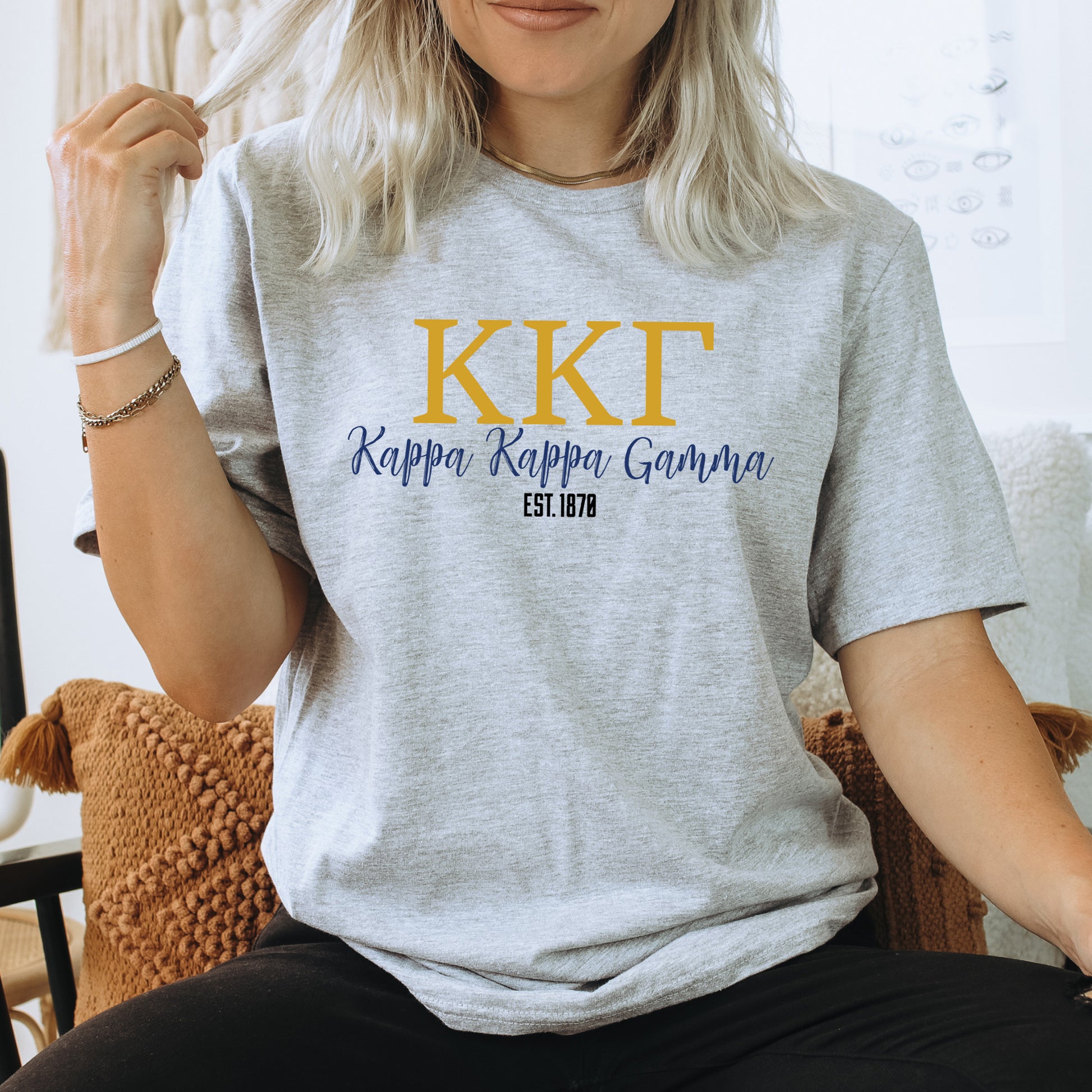 a woman sitting on a chair wearing a t - shirt