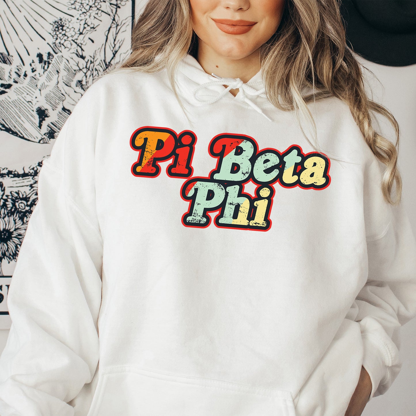 a woman wearing a white hoodie with the word pi beta pi on it