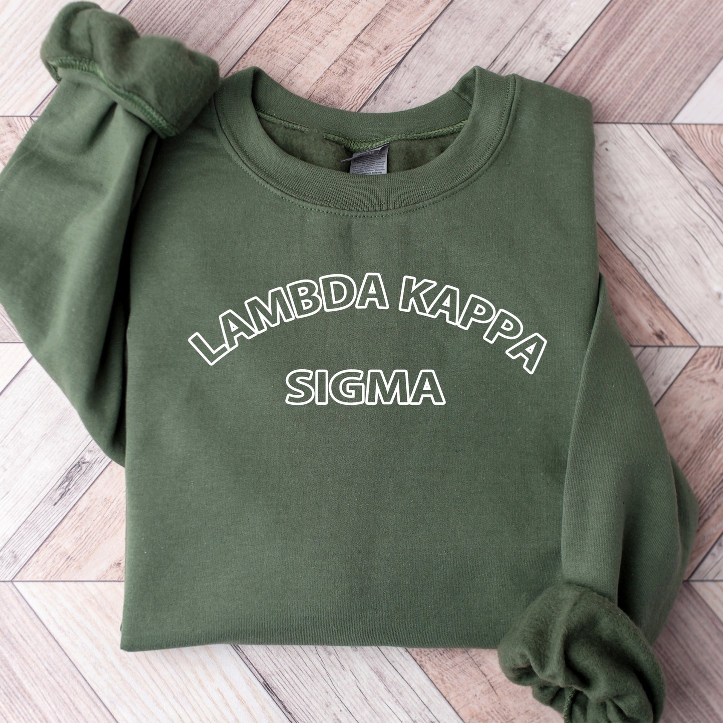 a green sweatshirt with the words lambda kapa sigma on it