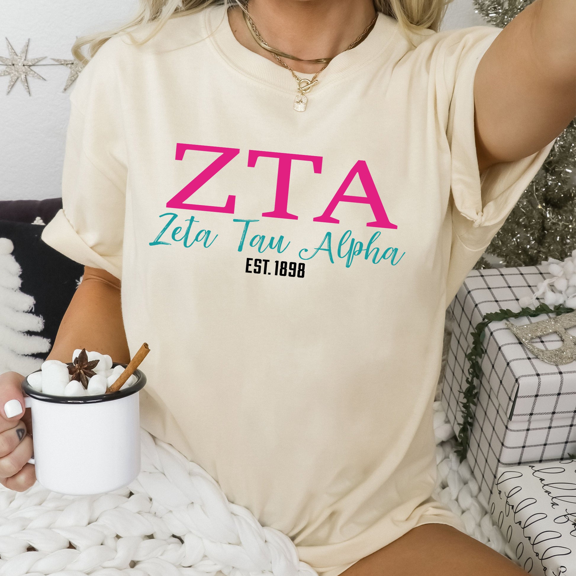 a woman sitting on a bed holding a cup of coffee