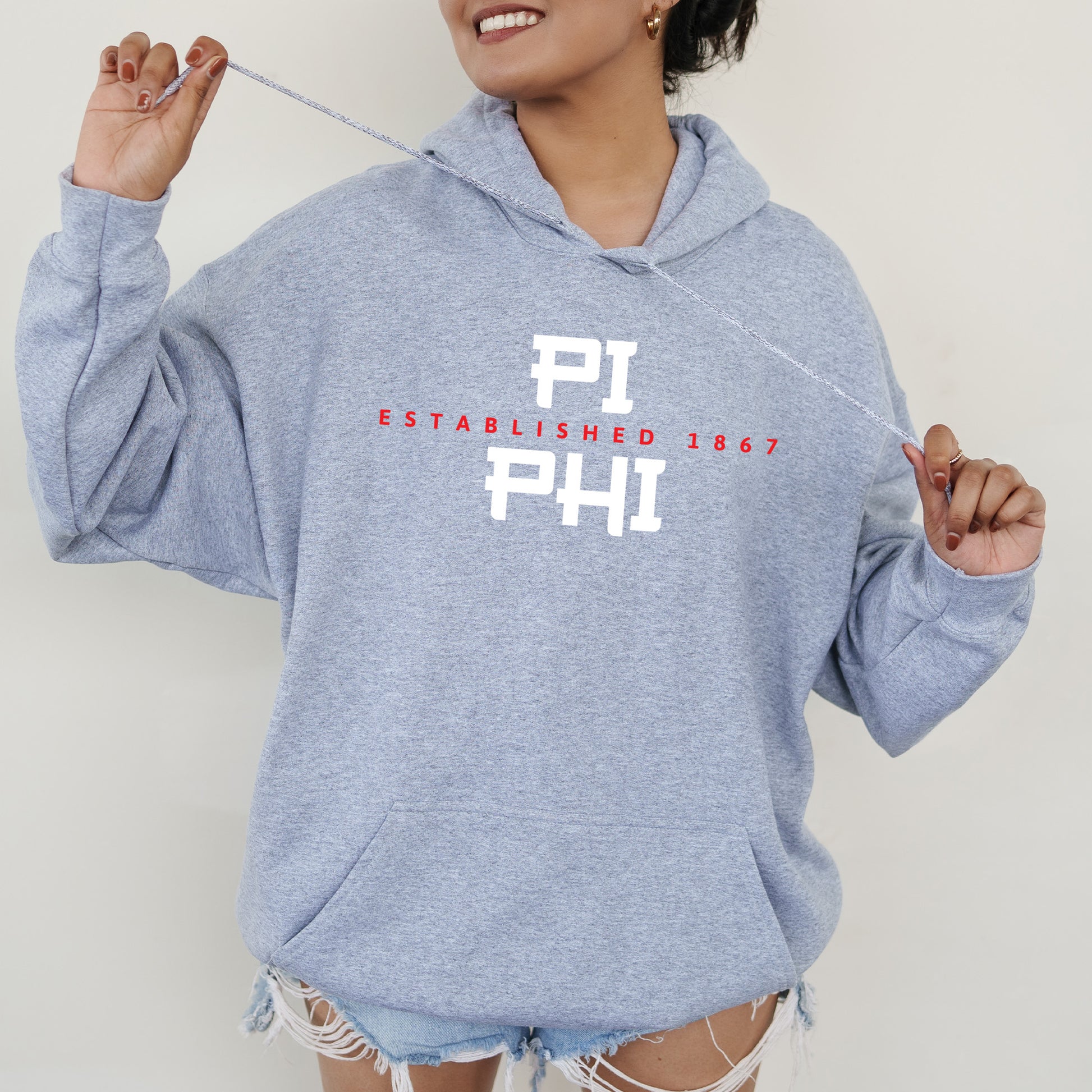 a woman in a blue hoodie is holding a string