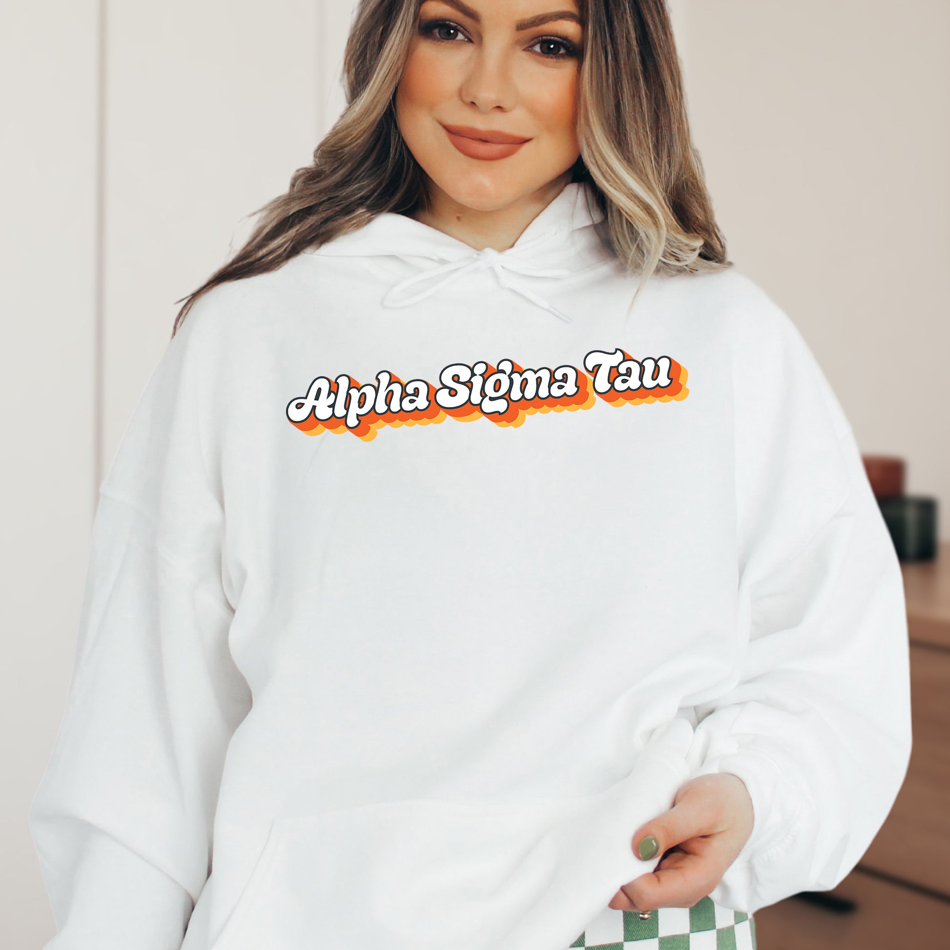 a woman wearing a white hoodie with a checkered bottom