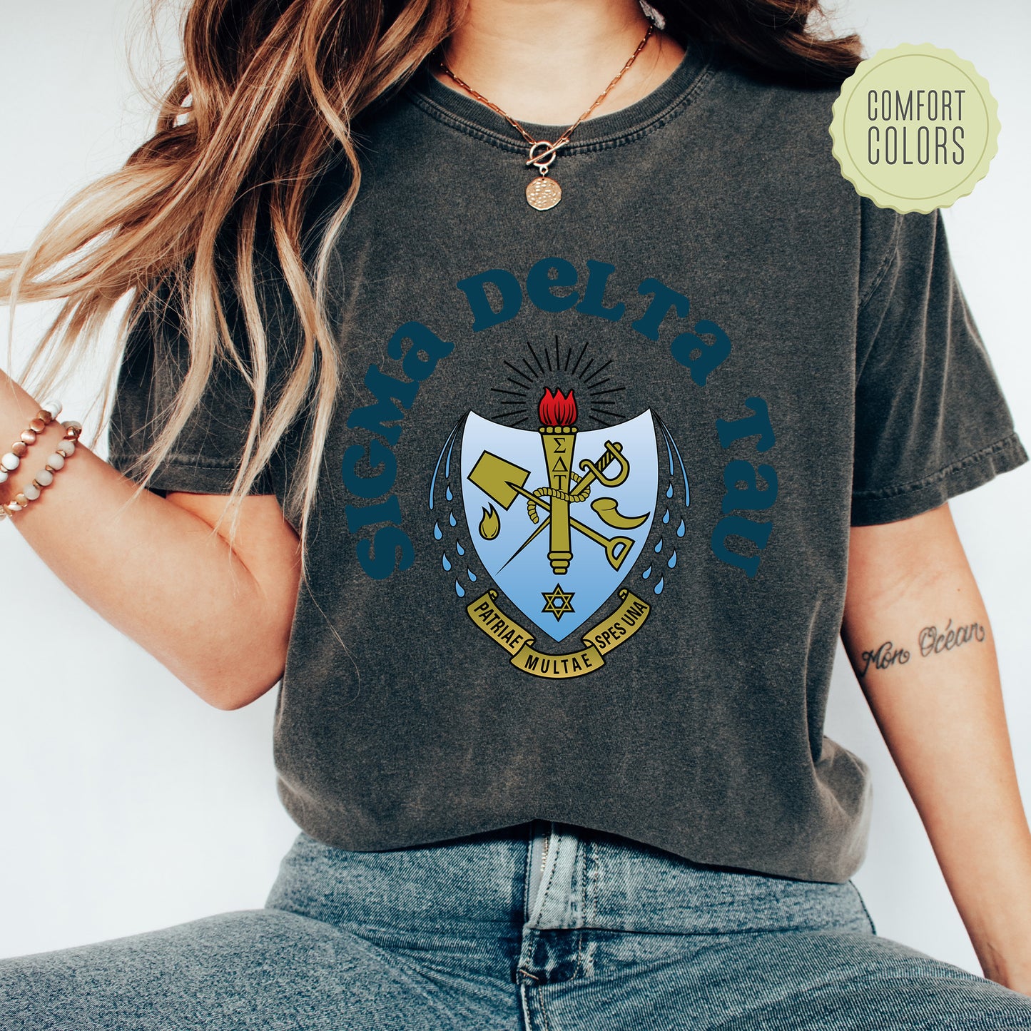 a woman wearing a t - shirt with a crest on it
