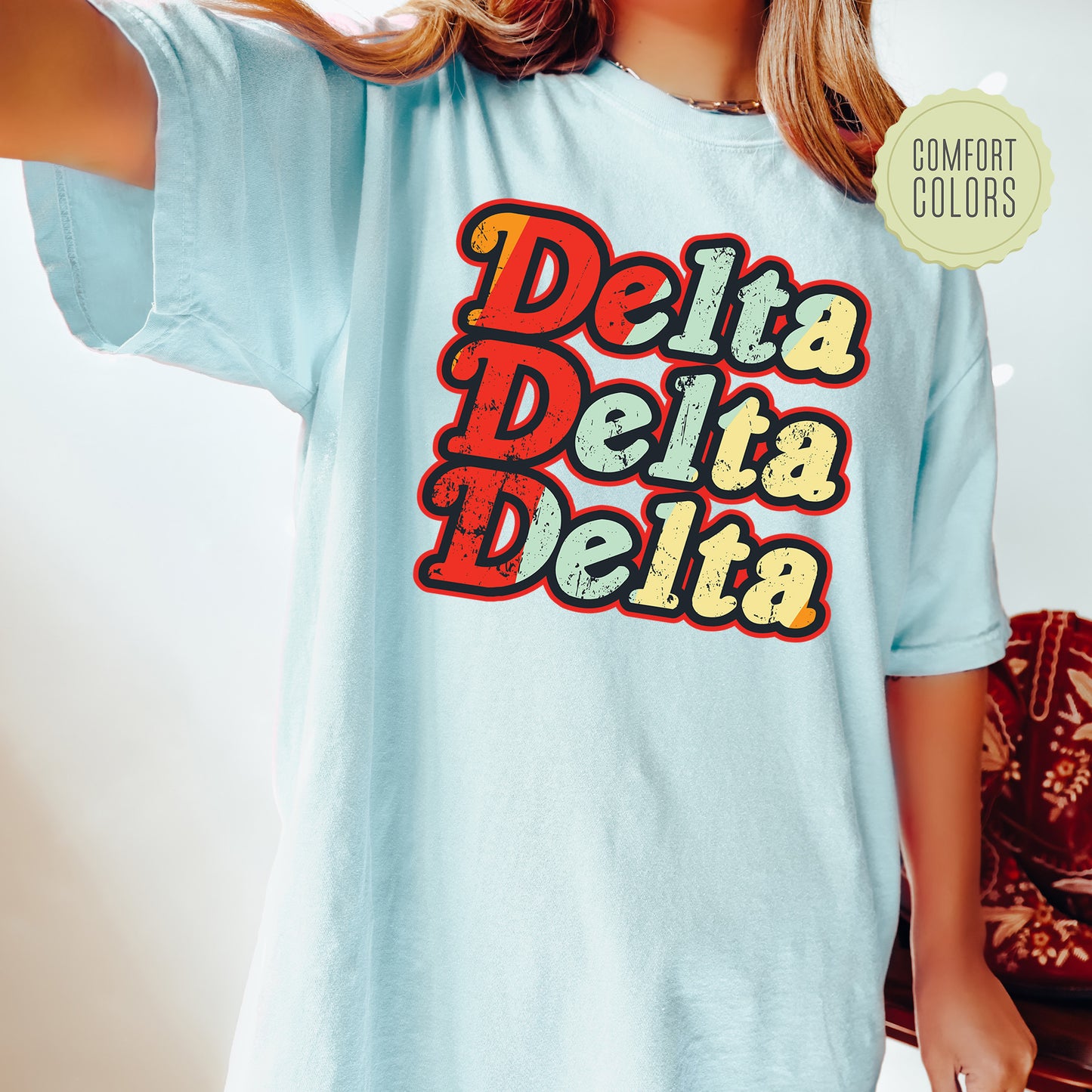 a woman wearing a blue shirt with the words delta delta on it
