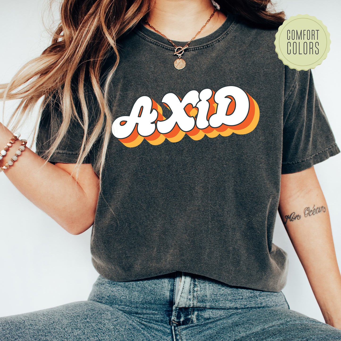 a woman wearing a black shirt with the word axid printed on it