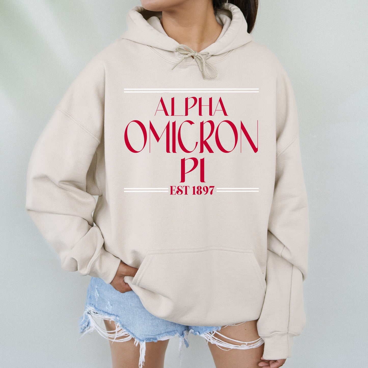 a woman wearing a white sweatshirt with the words,'alpha omgron