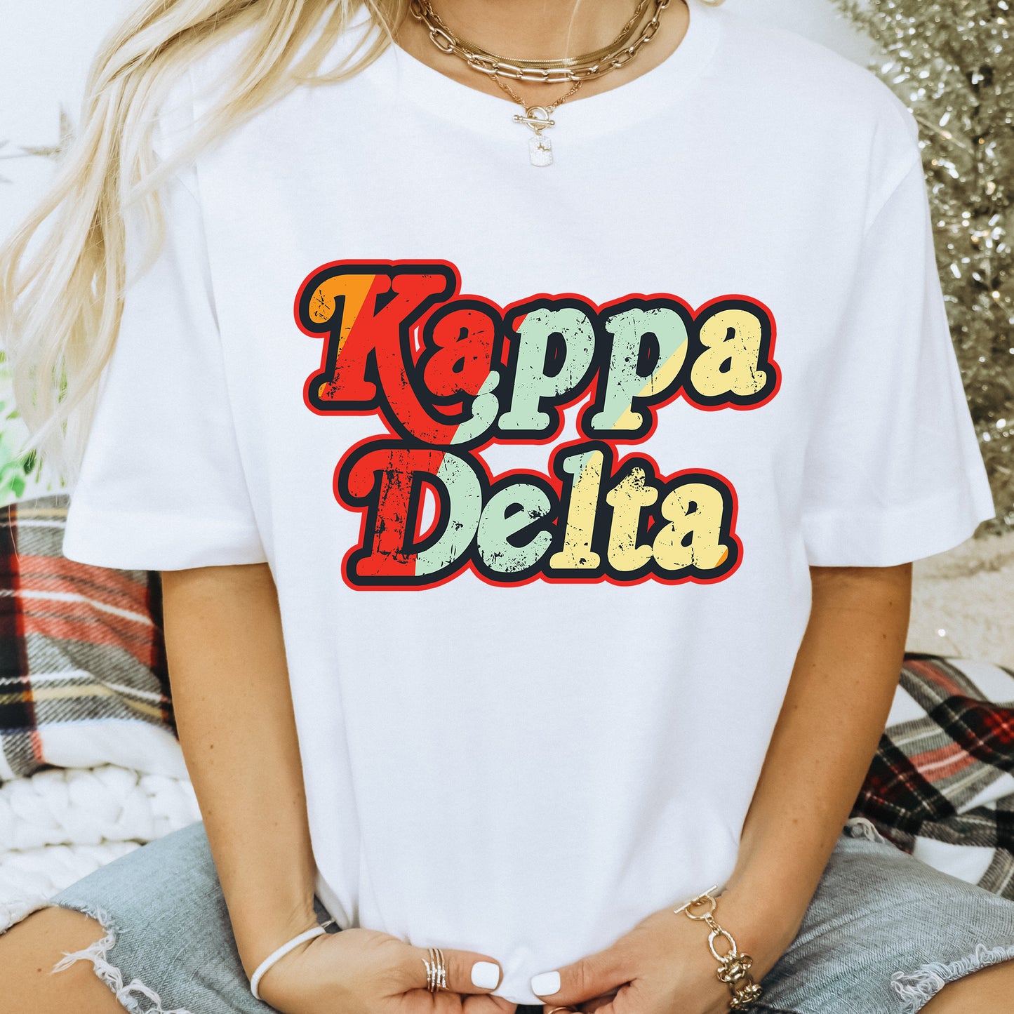 a woman wearing a white shirt that says kappa delta