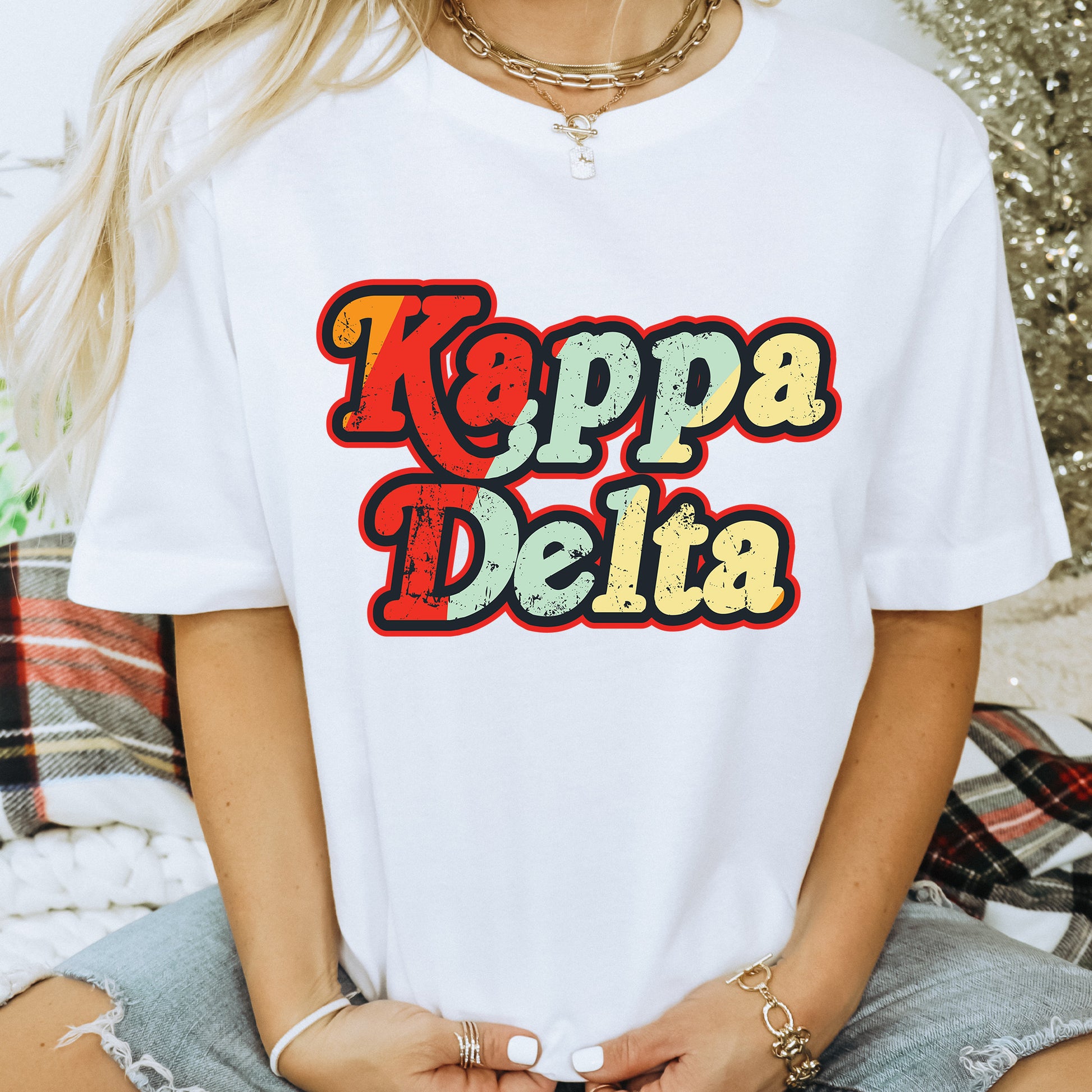 a woman wearing a white shirt that says kappa delta
