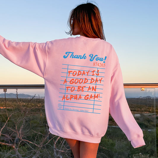 a woman wearing a pink sweatshirt with writing on it