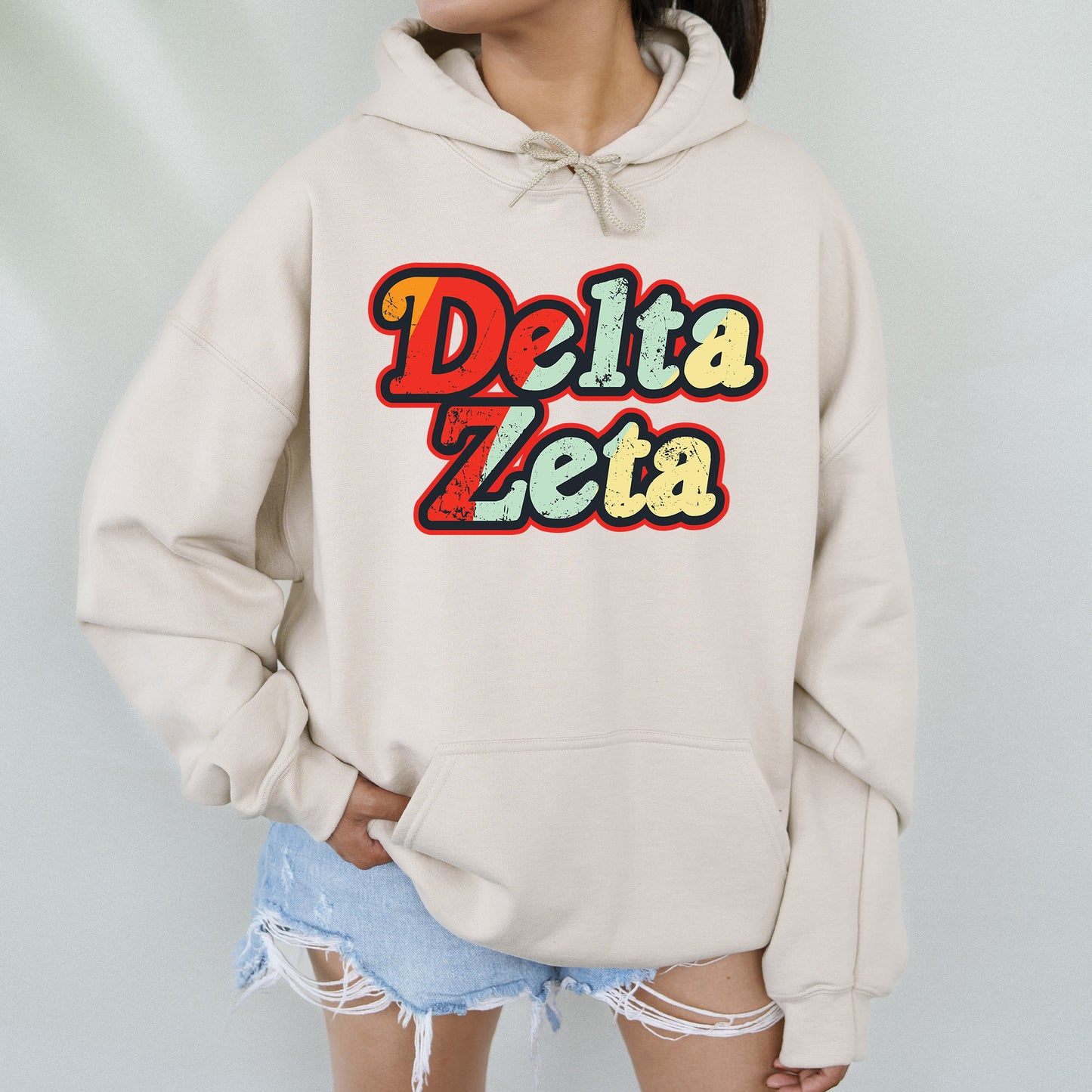a woman wearing a sweatshirt that says delta zeba