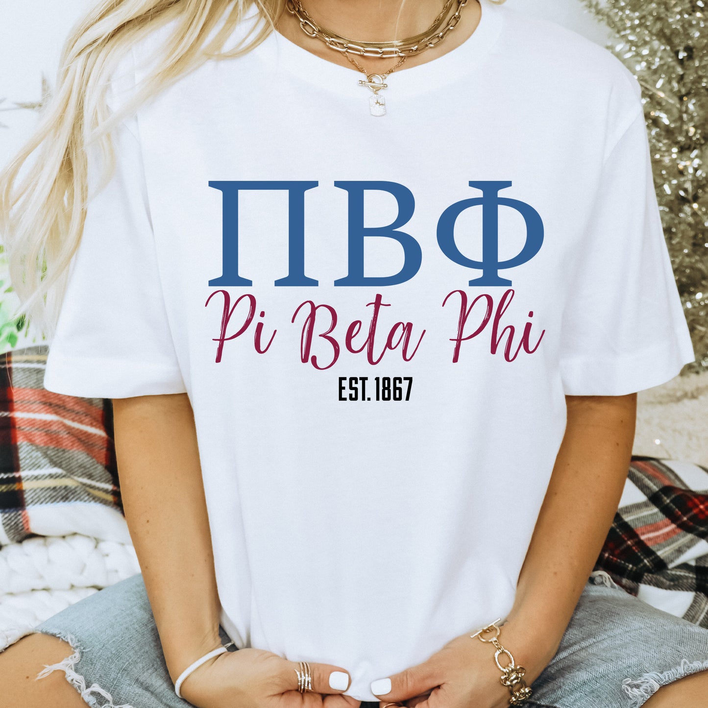 a woman wearing a white t - shirt that says pi beta phi