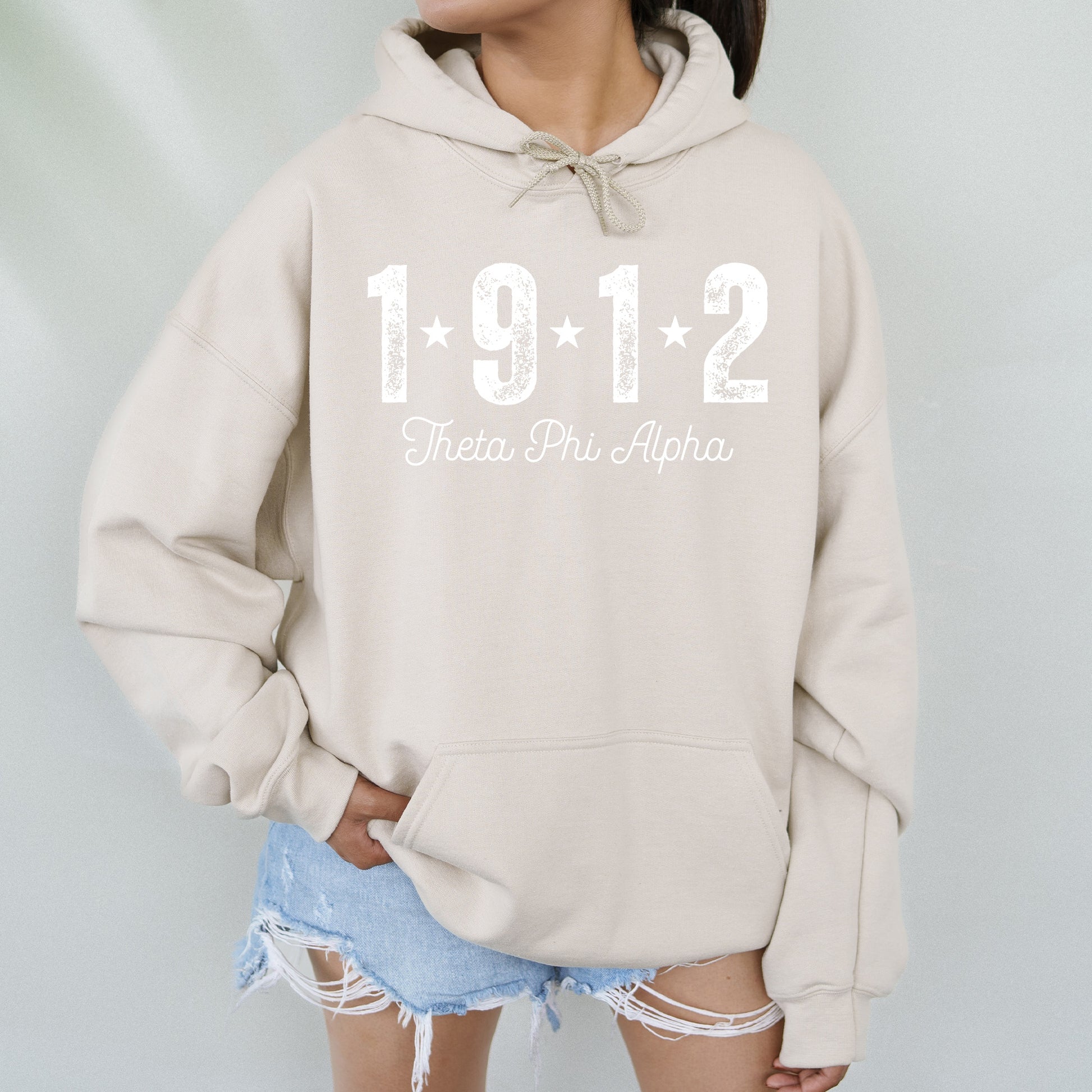 a woman wearing a sweatshirt with the number 1911 written on it