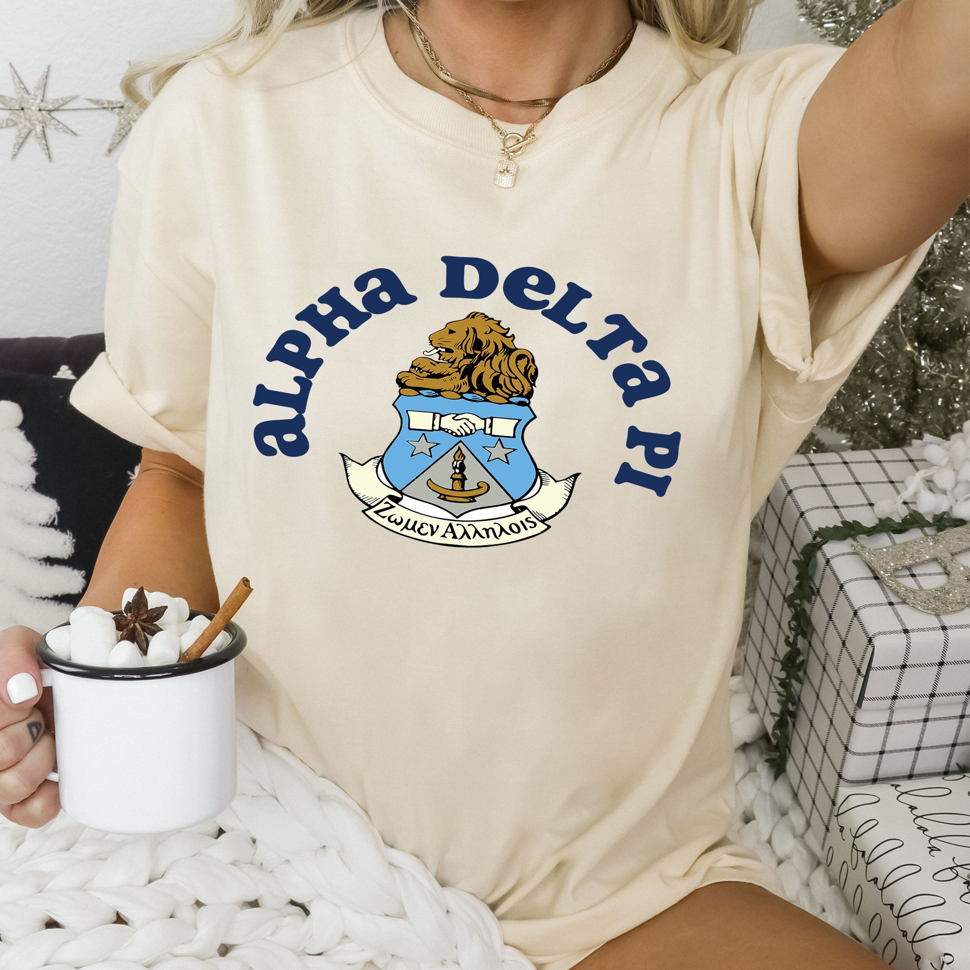 a woman sitting on a bed holding a cup of coffee