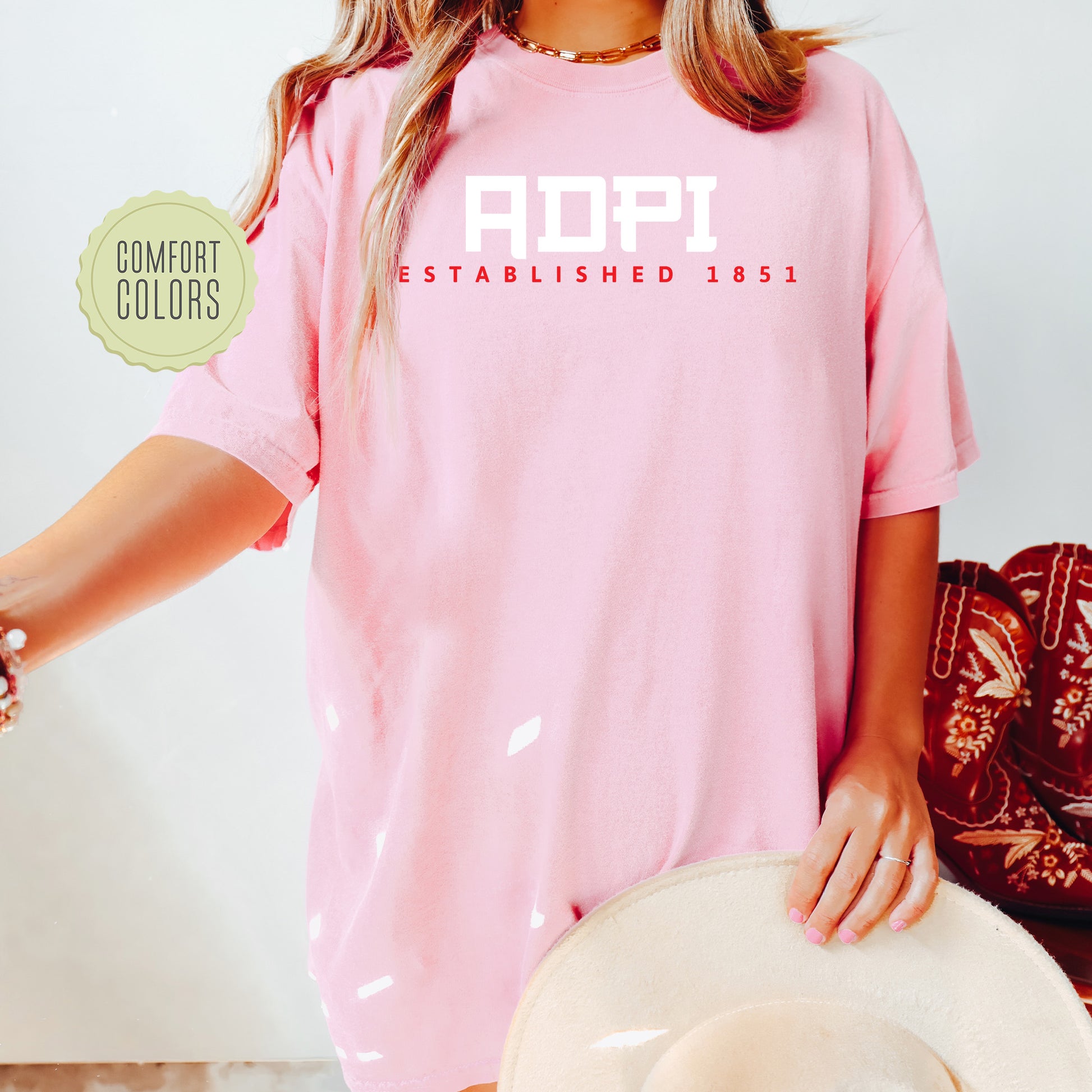 a woman wearing a pink shirt and hat
