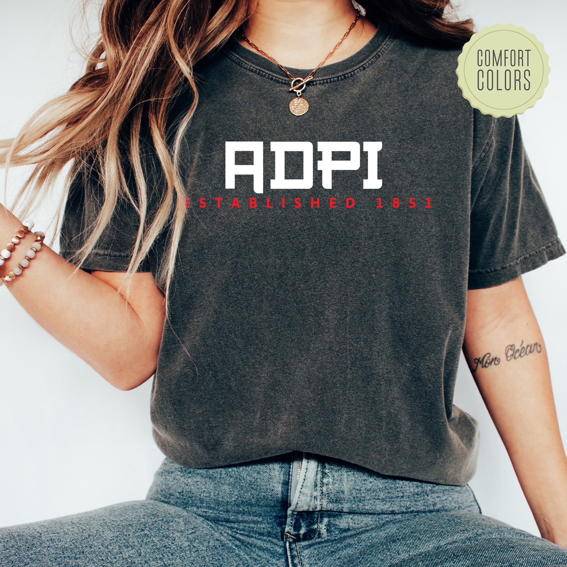 a woman wearing a black shirt with the word adpi printed on it