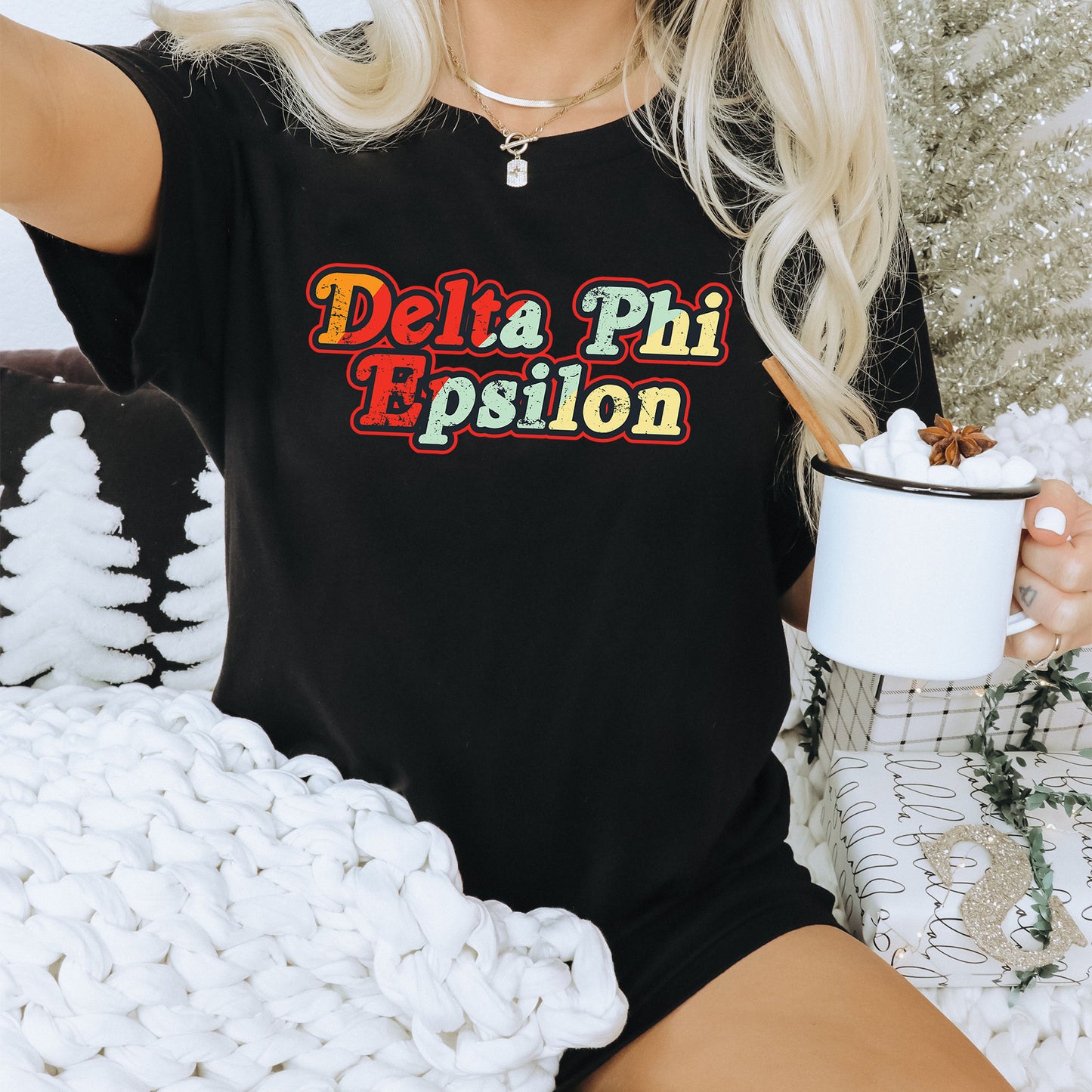 a woman sitting on a couch holding a cup of coffee