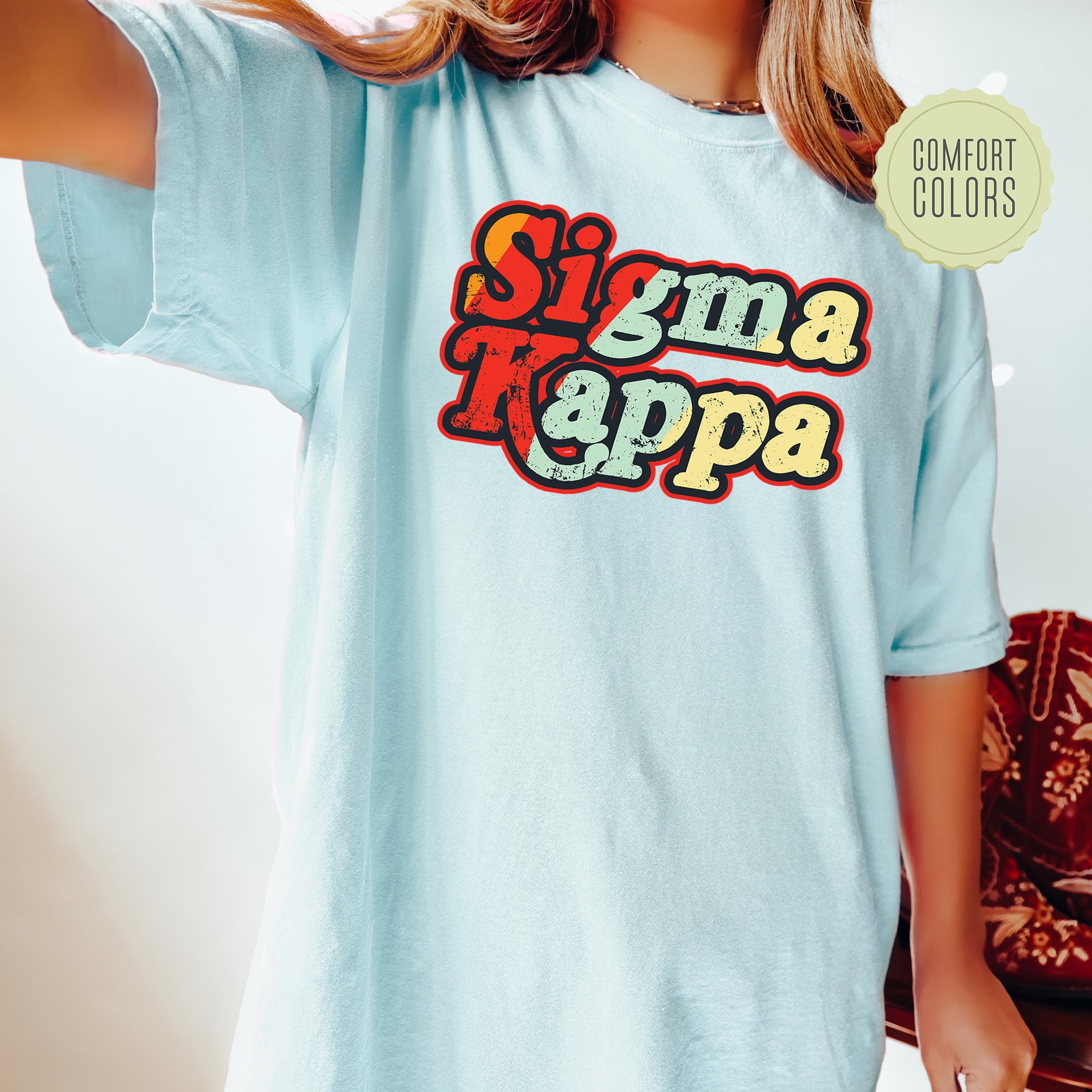 a woman wearing a blue shirt that says singma kappa