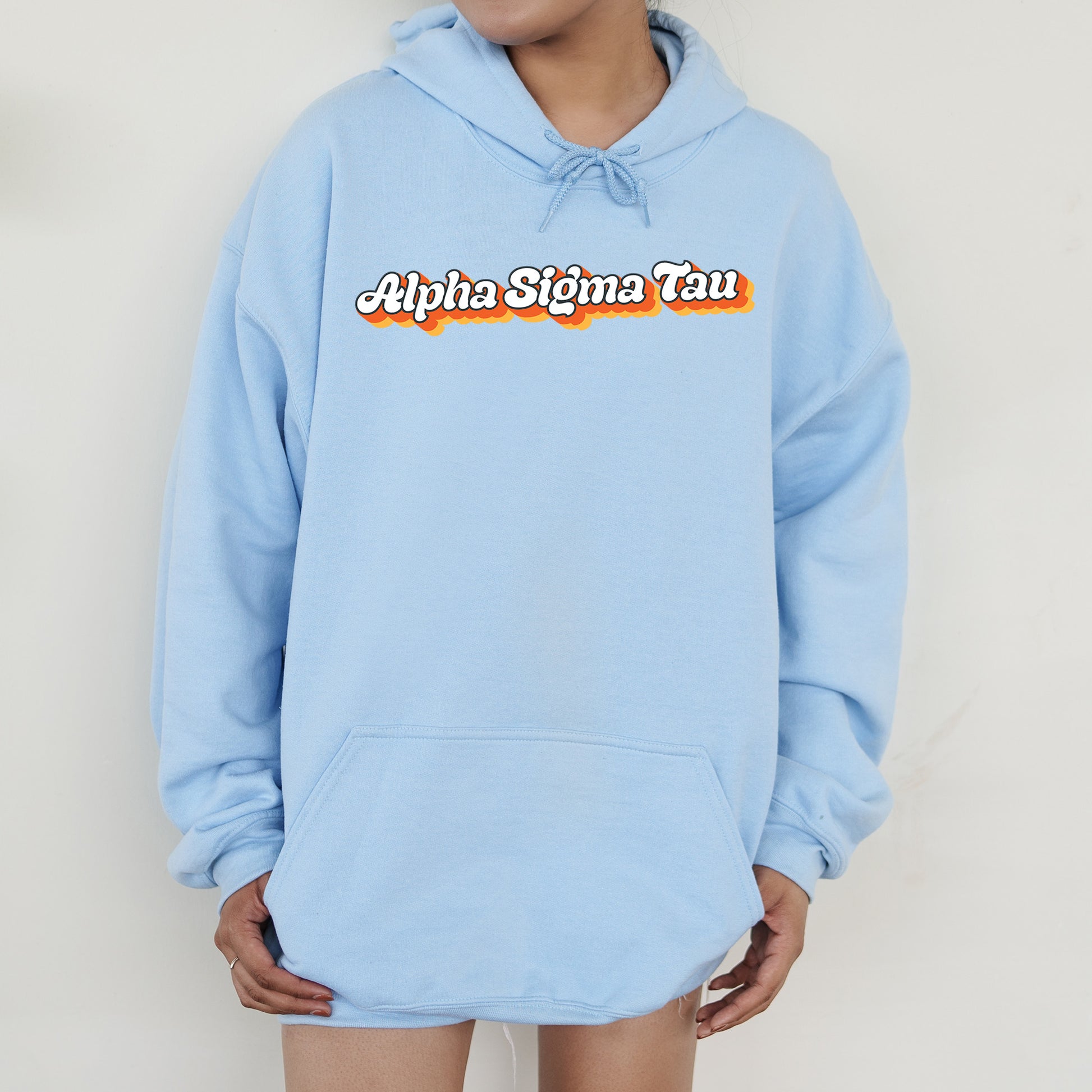a person wearing a blue hoodie with the words aloha singa tau