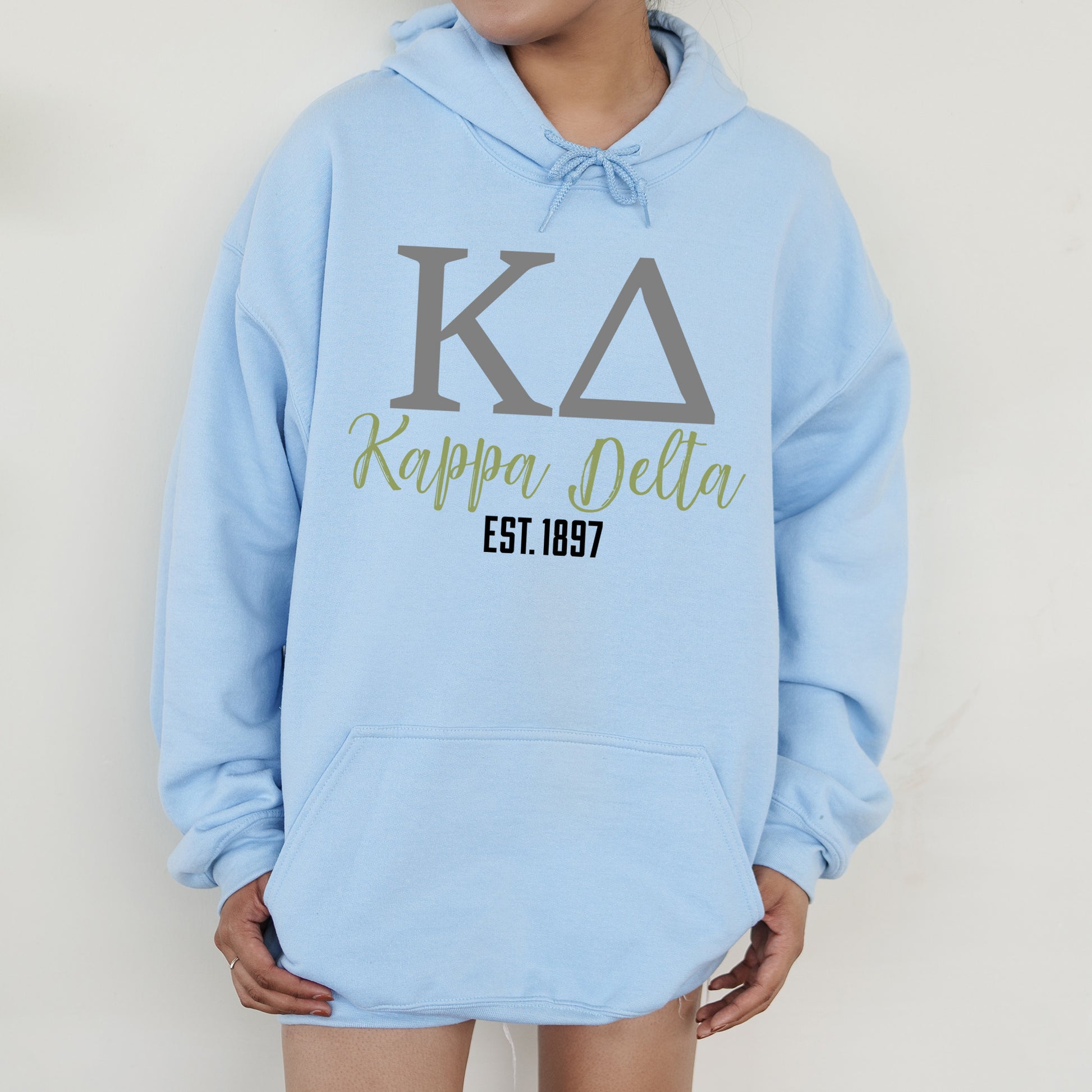 a person wearing a blue hoodie that says kappera delta est 1897