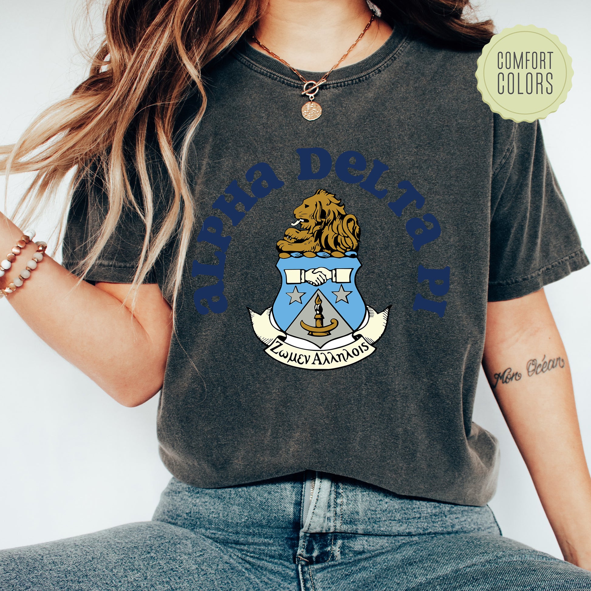 a woman wearing a t - shirt with a coat of arms on it