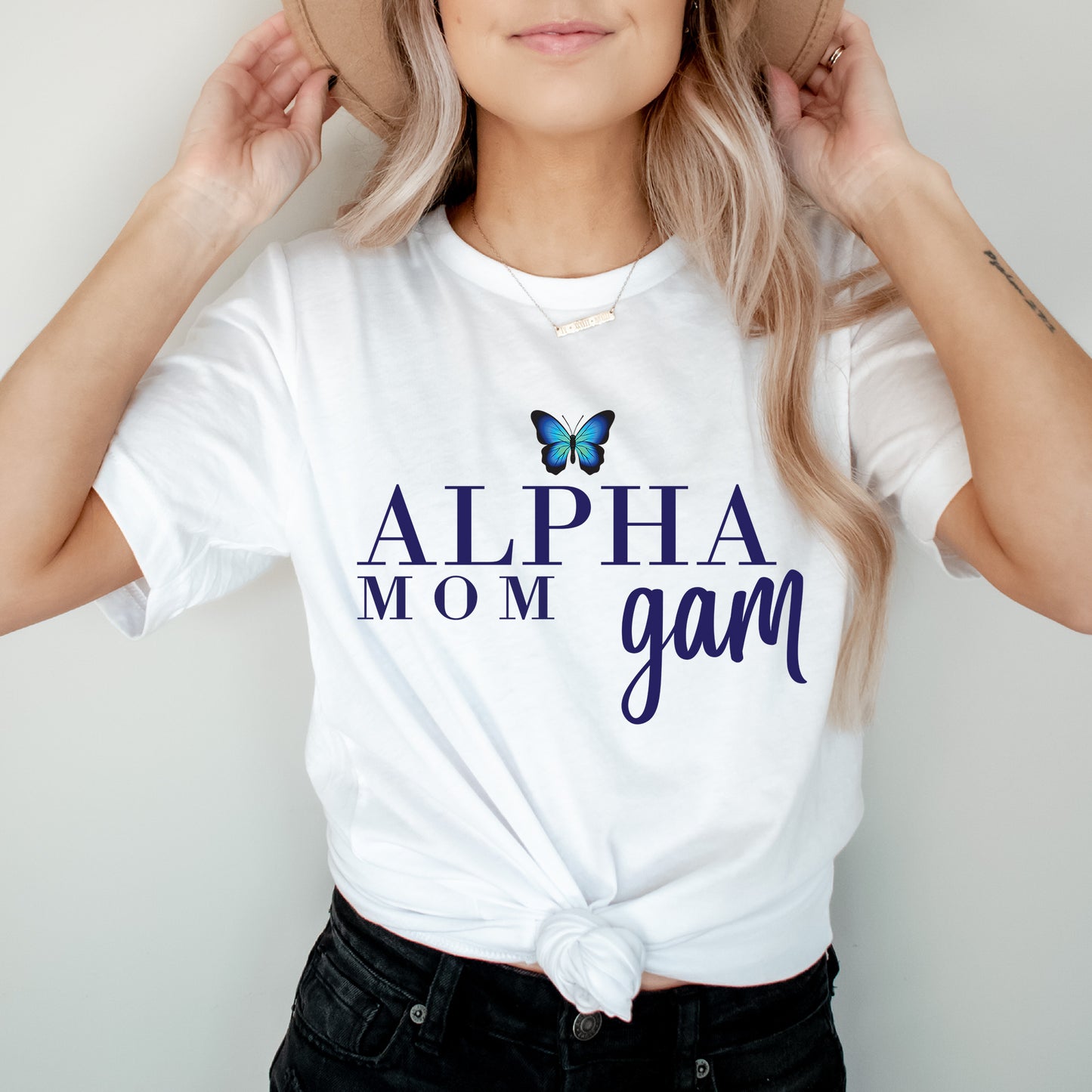 a woman wearing a white shirt with a butterfly on it