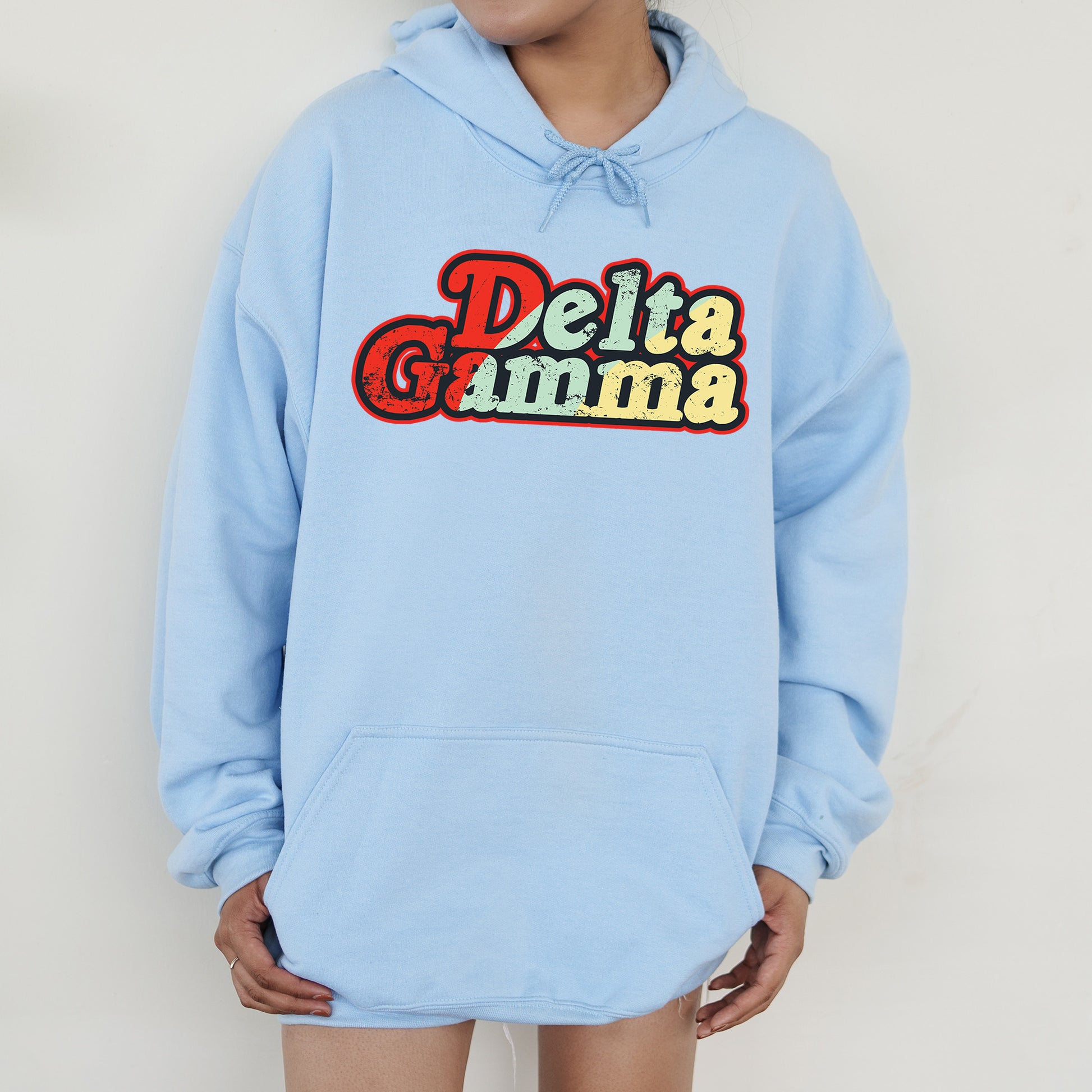a person wearing a blue hoodie that says delta gumma