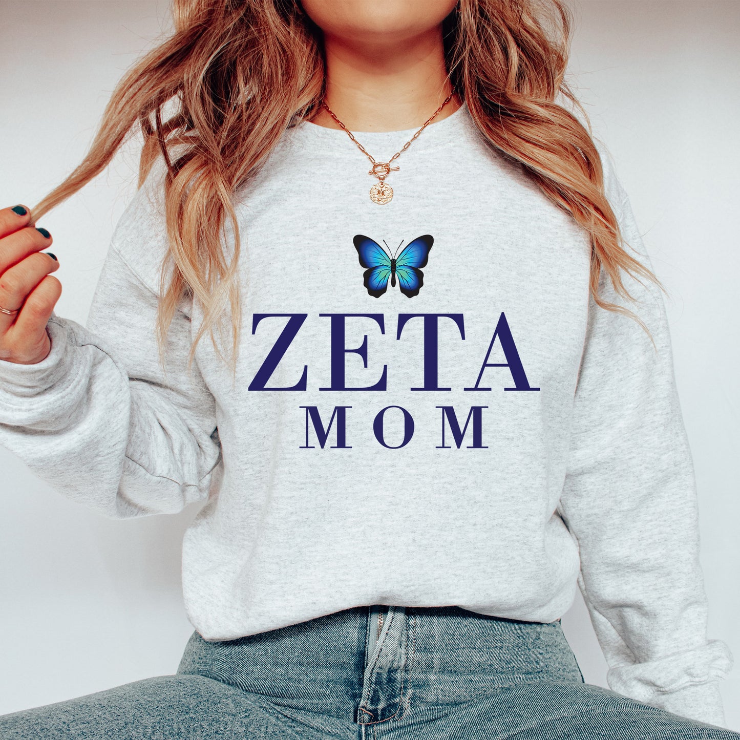 a woman wearing a sweatshirt with a butterfly on it
