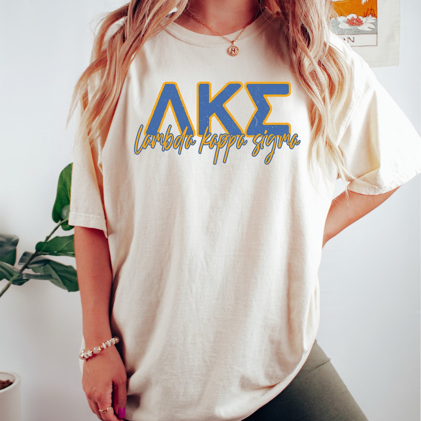 a woman wearing a white shirt with the letters ake on it