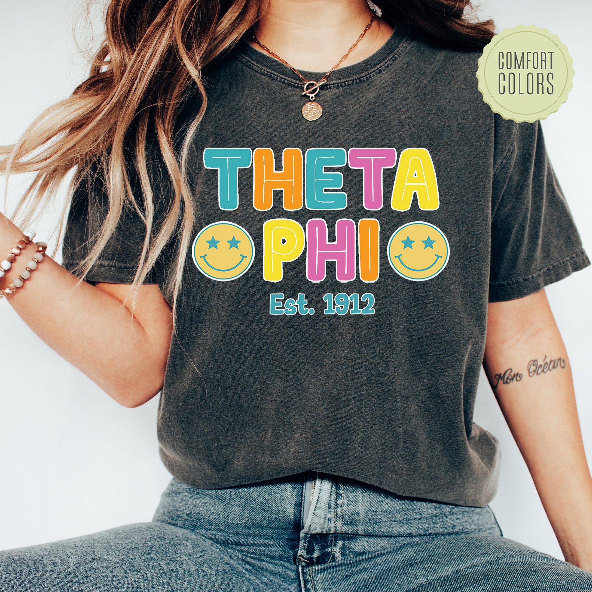 a woman wearing a t - shirt that says thea phi