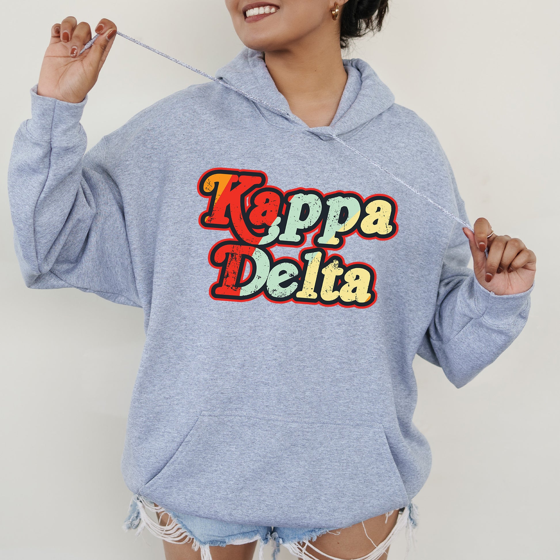 a woman wearing a blue hoodie with the words pepa delta printed on it