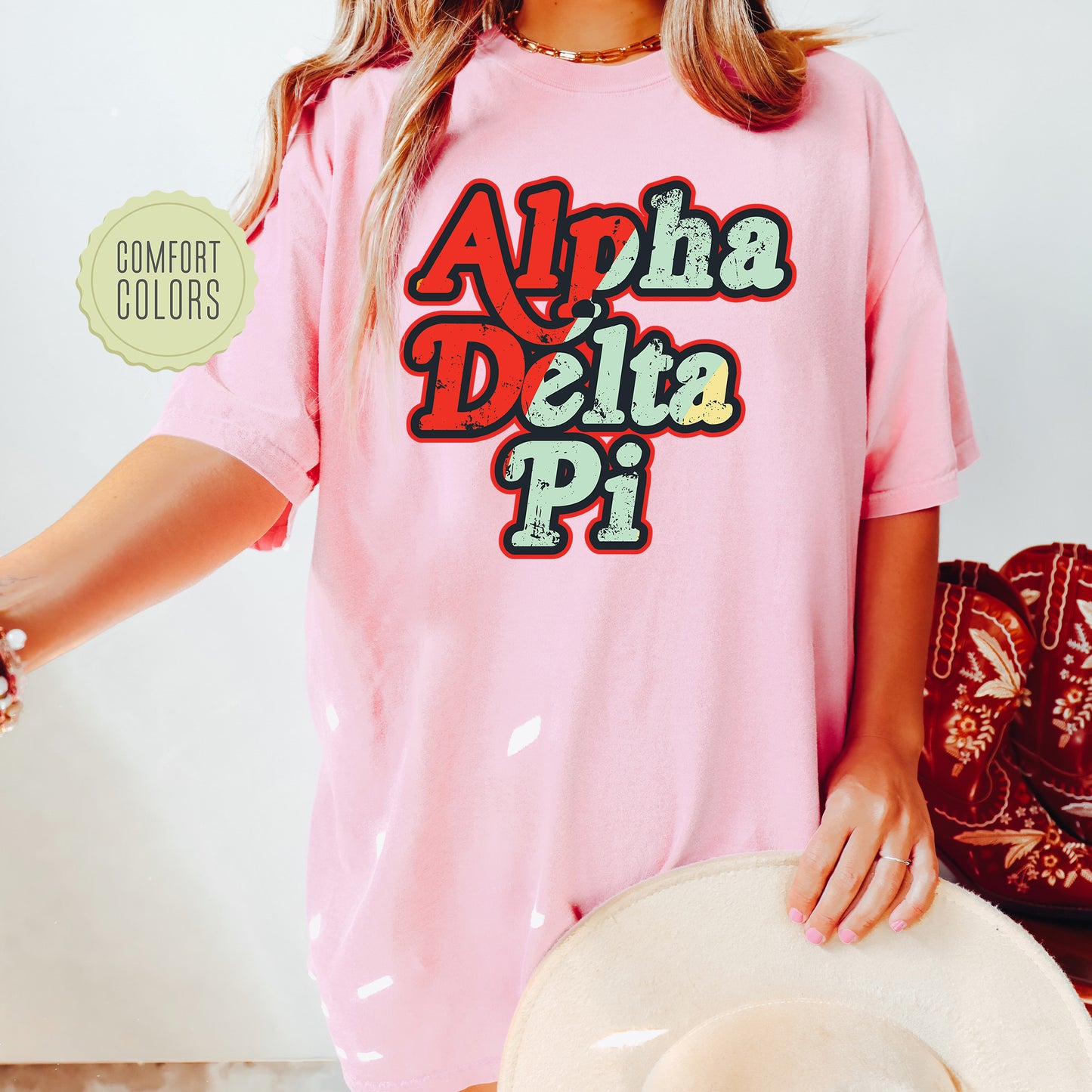 a woman wearing a pink shirt that says aloh delta pi