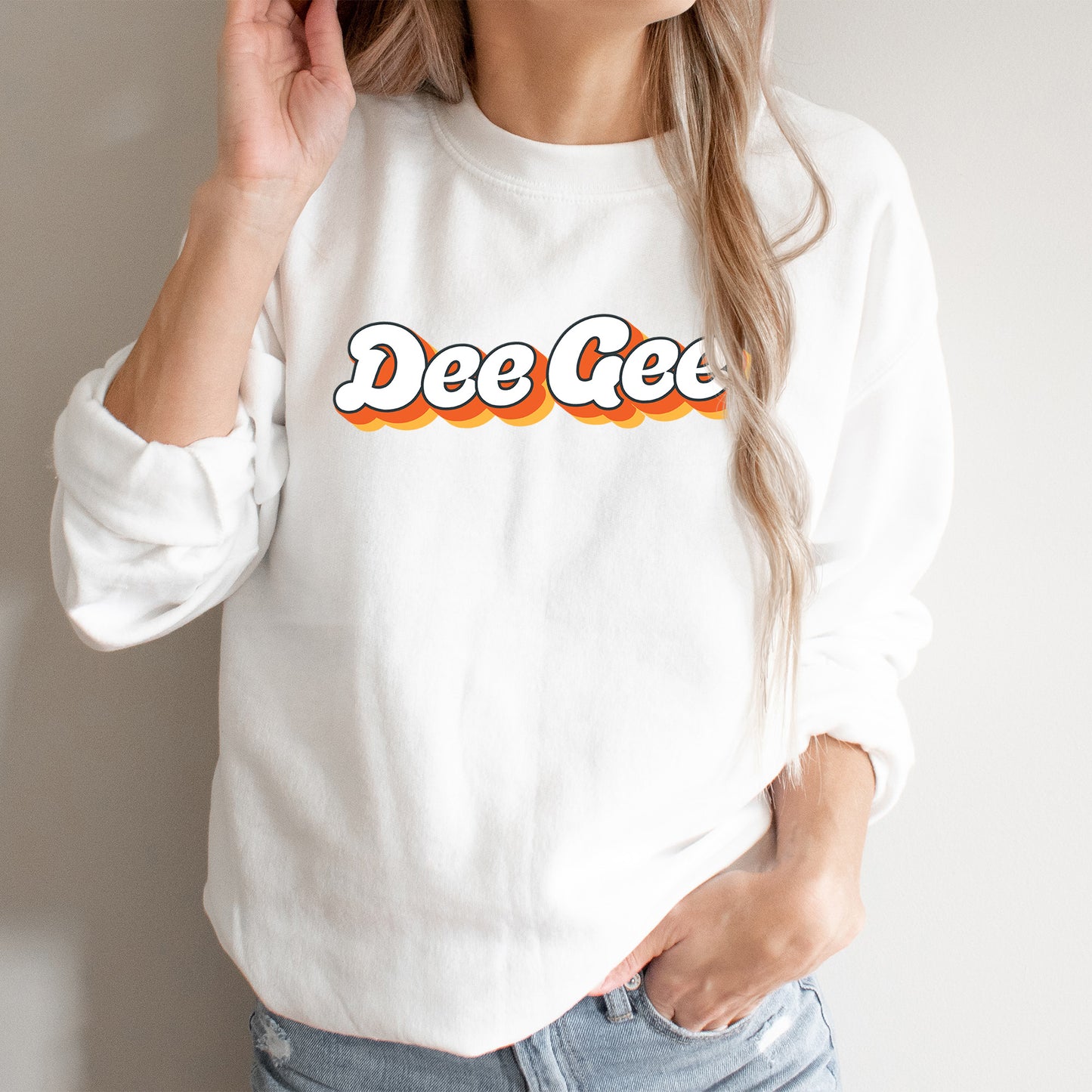 a woman wearing a white sweatshirt with the word dee gee on it