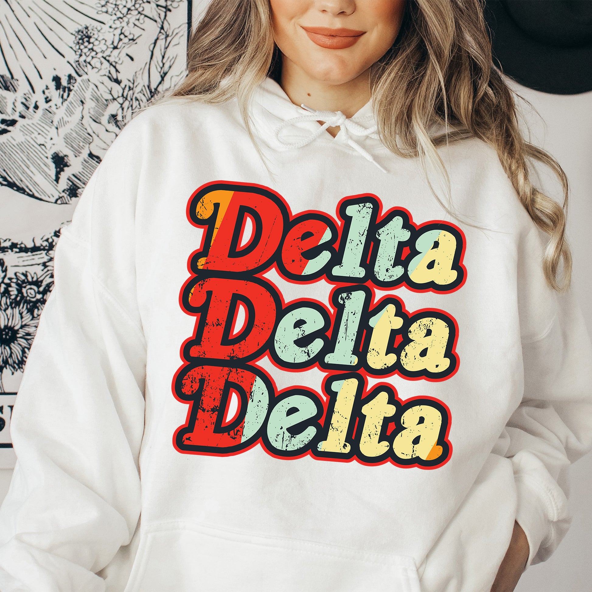 a woman wearing a white hoodie with the words delta delta printed on it