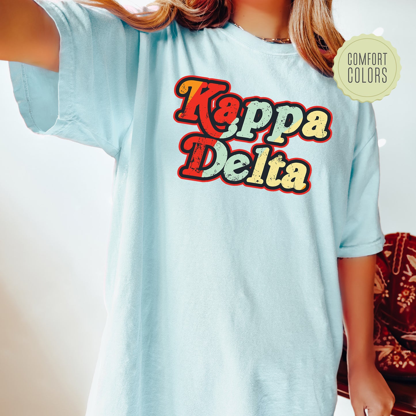 a woman wearing a t - shirt that says kappa delia