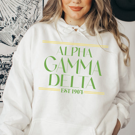a woman wearing a white hoodie with a green and yellow logo