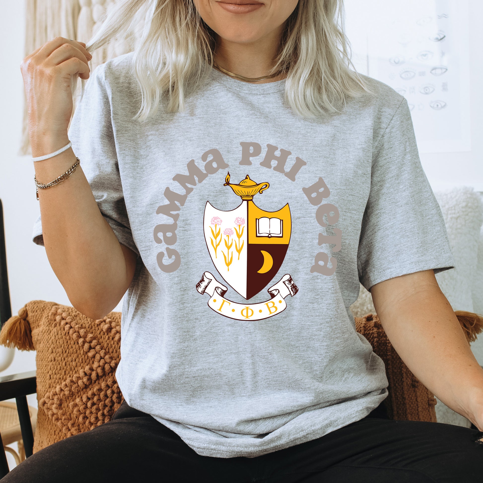 a woman sitting on a chair wearing a gray shirt
