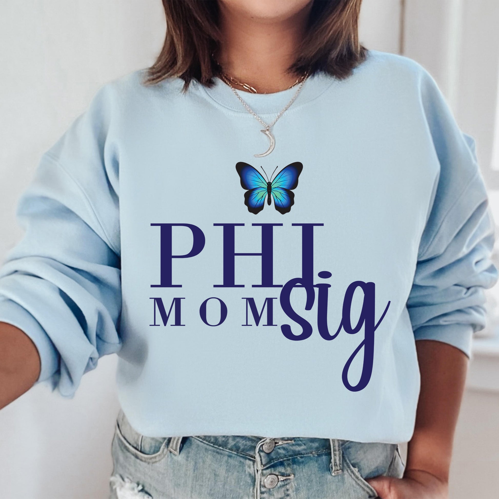 a woman wearing a blue sweatshirt with a butterfly on it