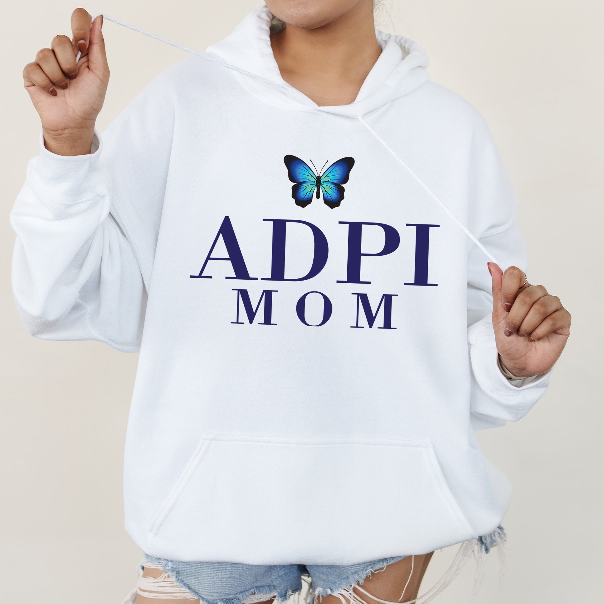 a woman wearing a white hoodie with a butterfly on it
