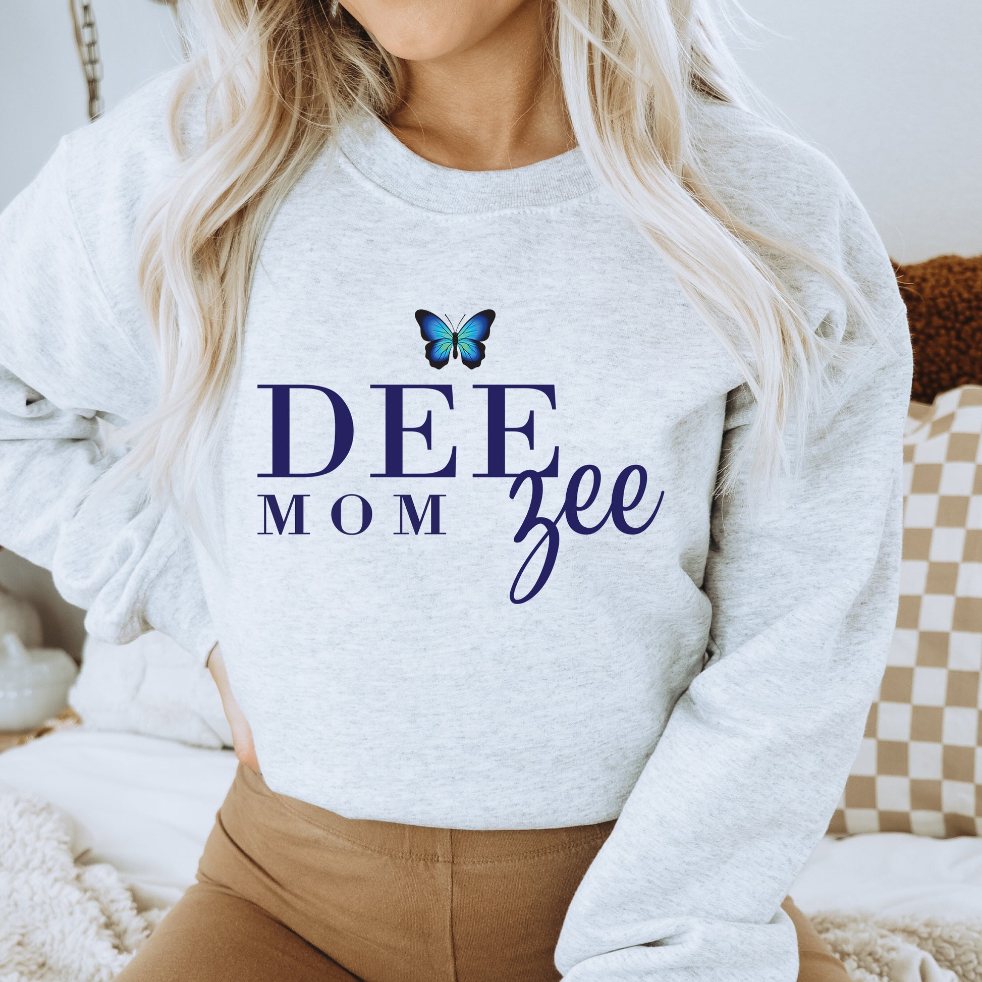 a woman wearing a sweatshirt that says deee mom free