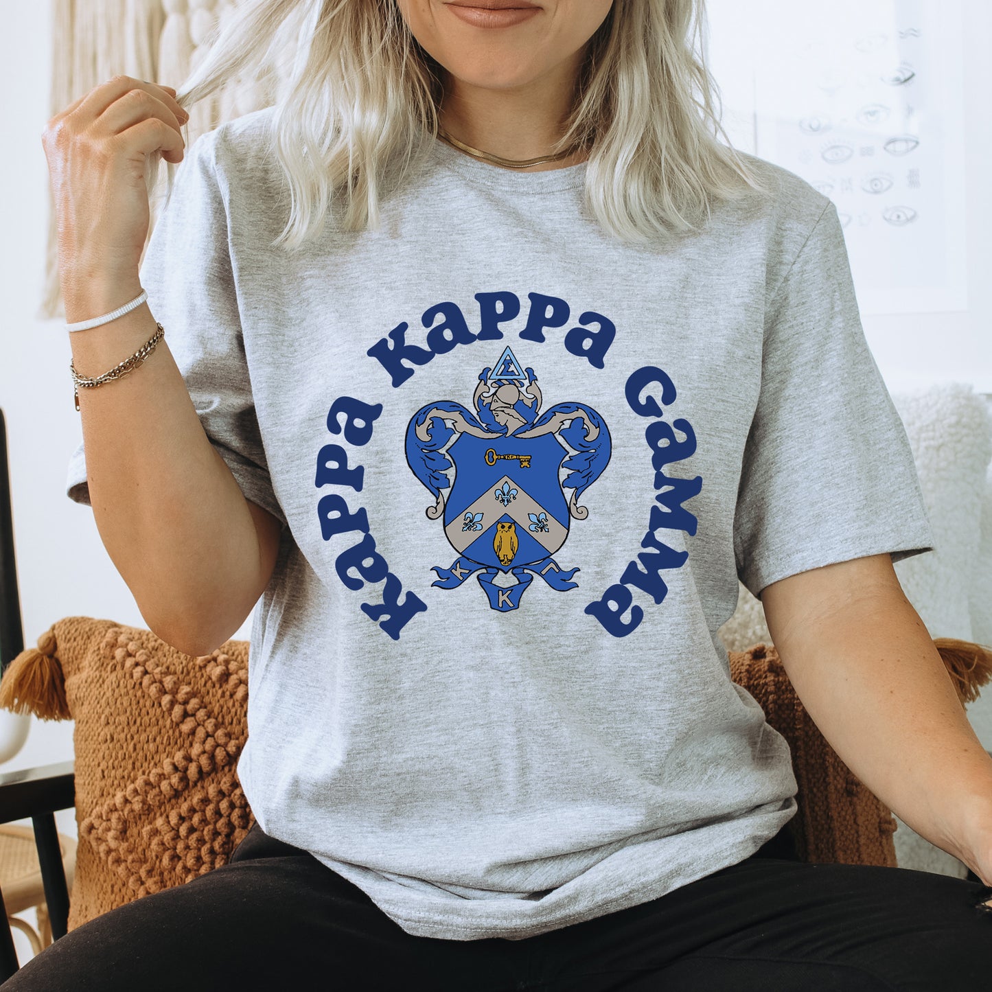 a woman sitting on a chair wearing a t - shirt that says happy kapp