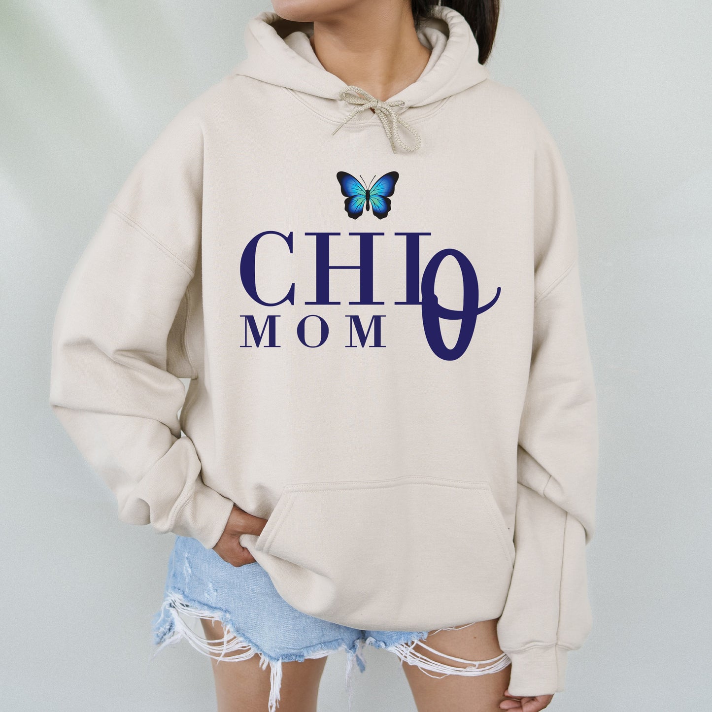 a woman wearing a hoodie with a butterfly on it
