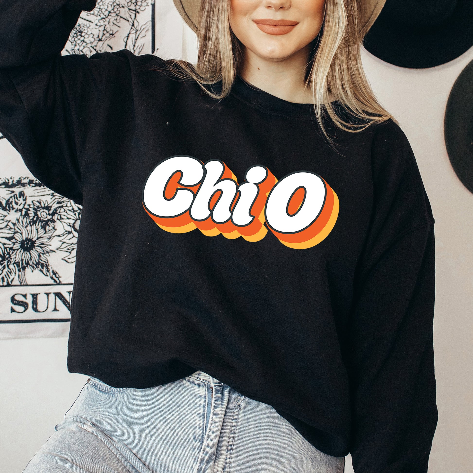 a woman wearing a black sweatshirt with the word chio on it