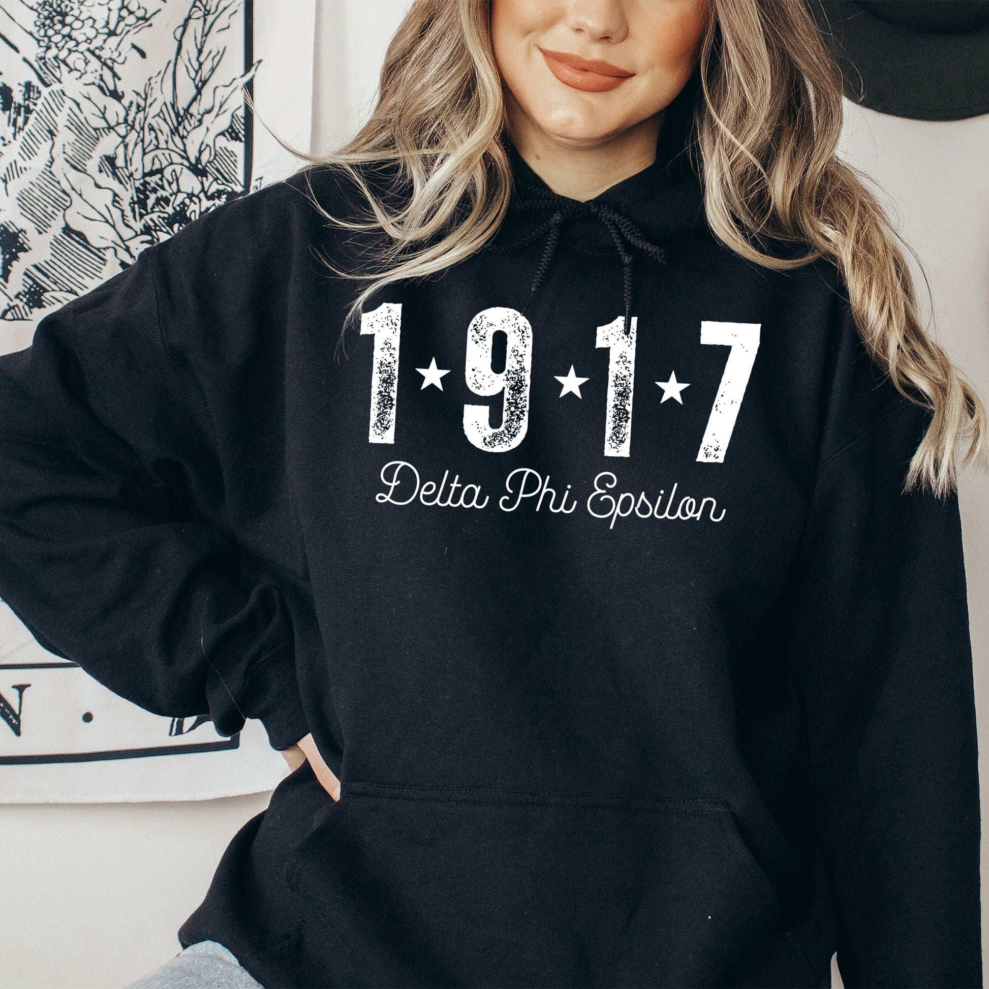 a woman wearing a black hoodie with the number 1917 written on it