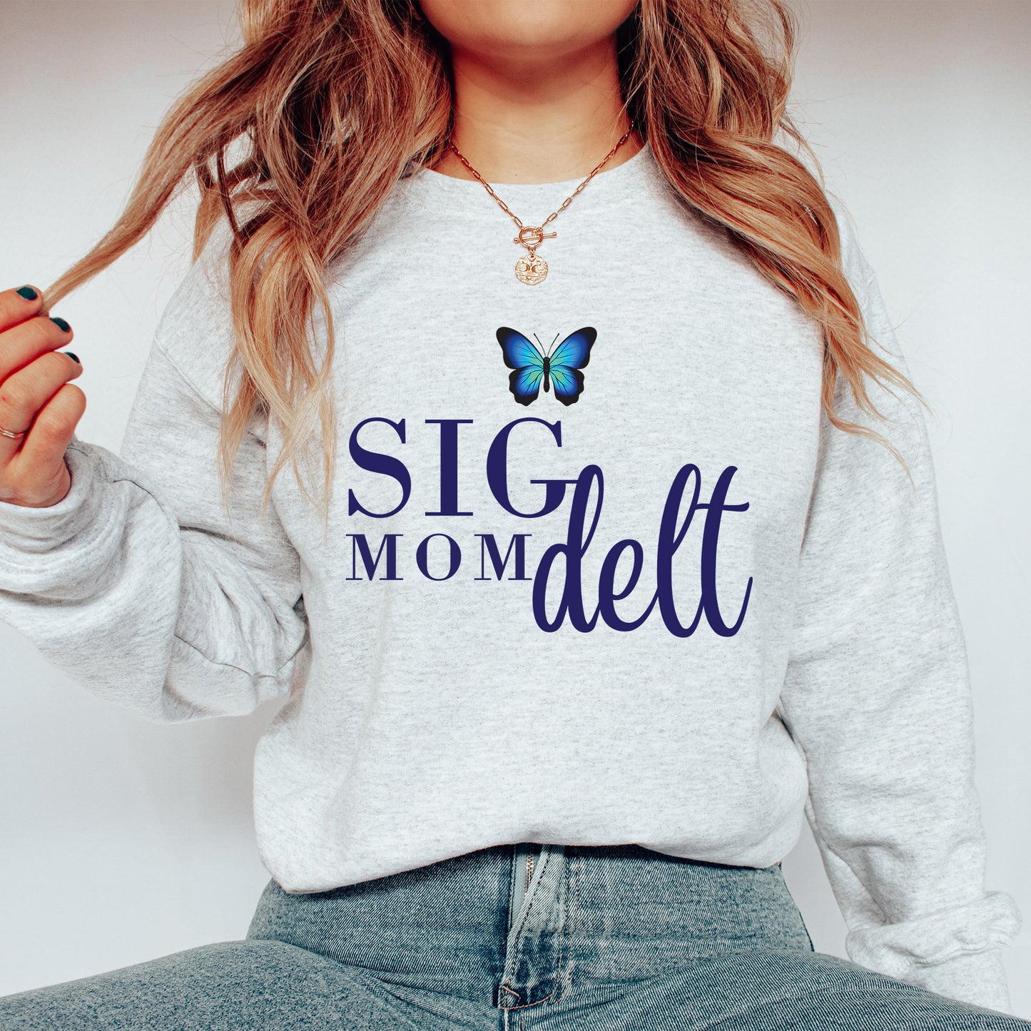 a woman wearing a sweatshirt with a butterfly on it