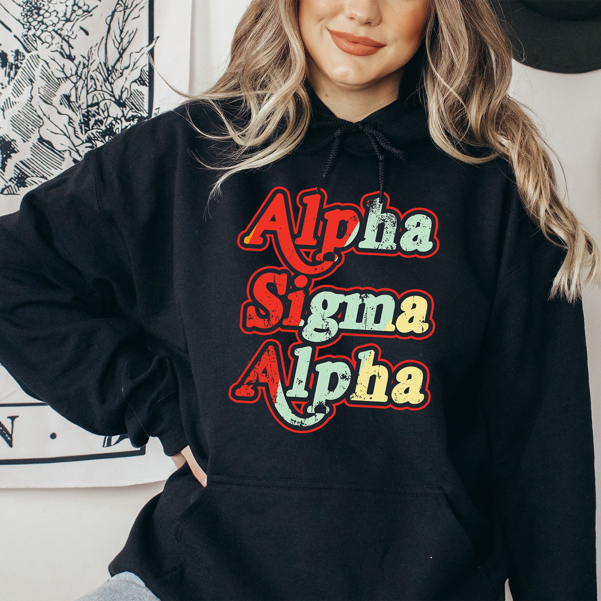 a woman wearing a black hoodie with the word aloha on it