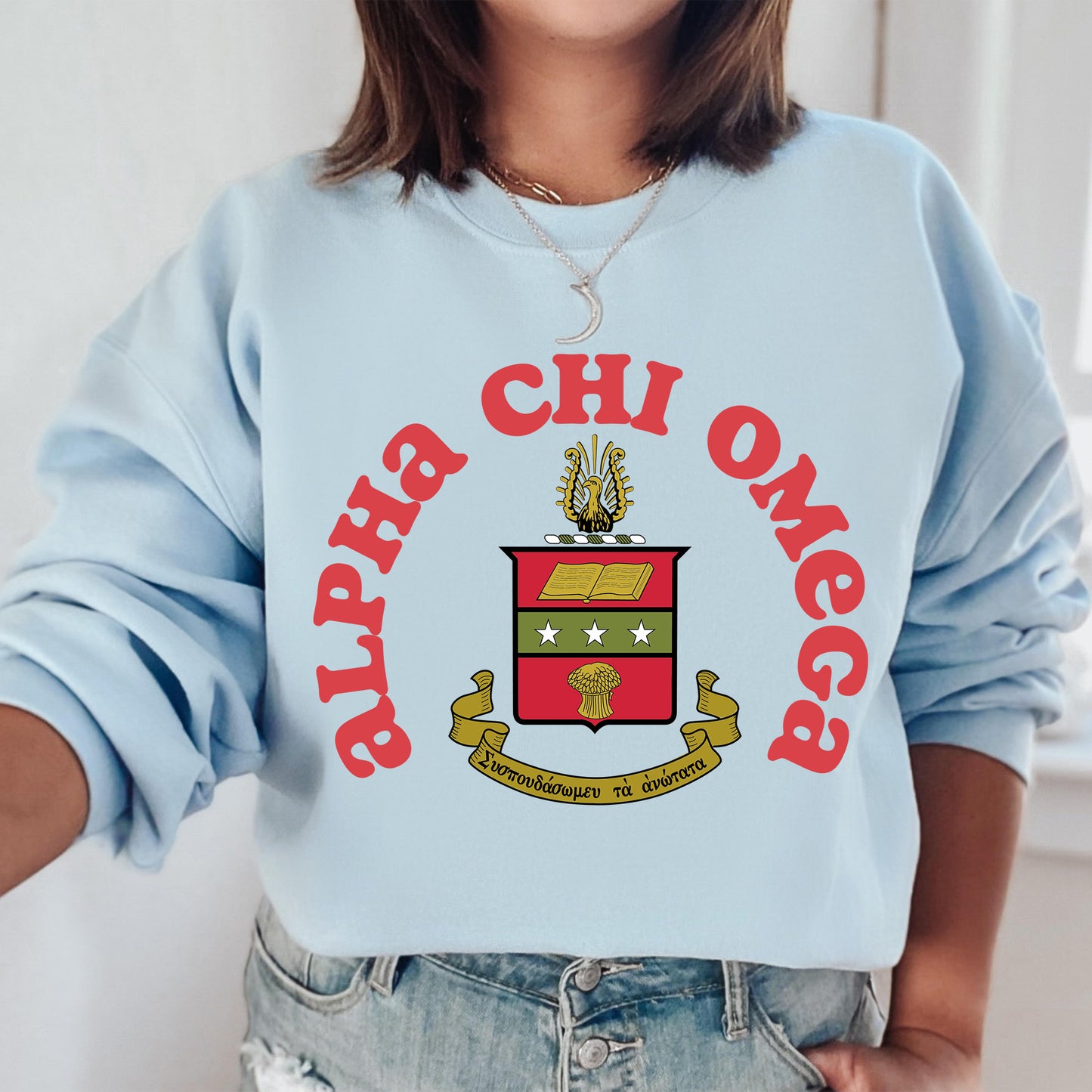 a woman wearing a blue sweatshirt with a crest on it