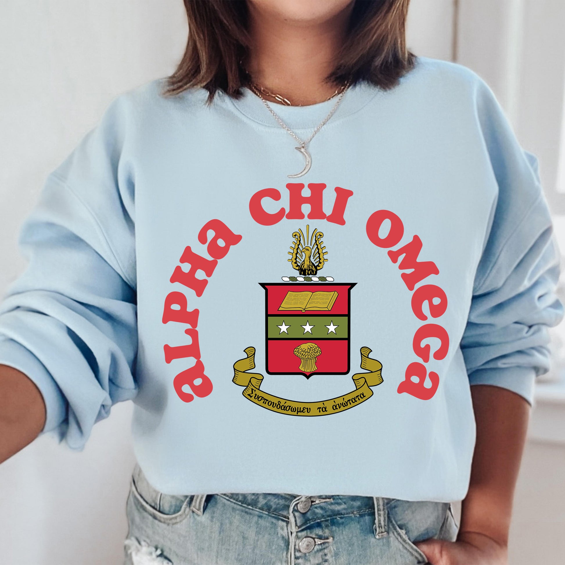 a woman wearing a blue sweatshirt with a crest on it