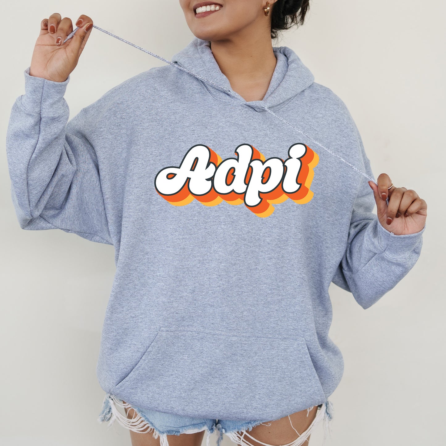 a woman wearing a blue hoodie with the word adpi printed on it