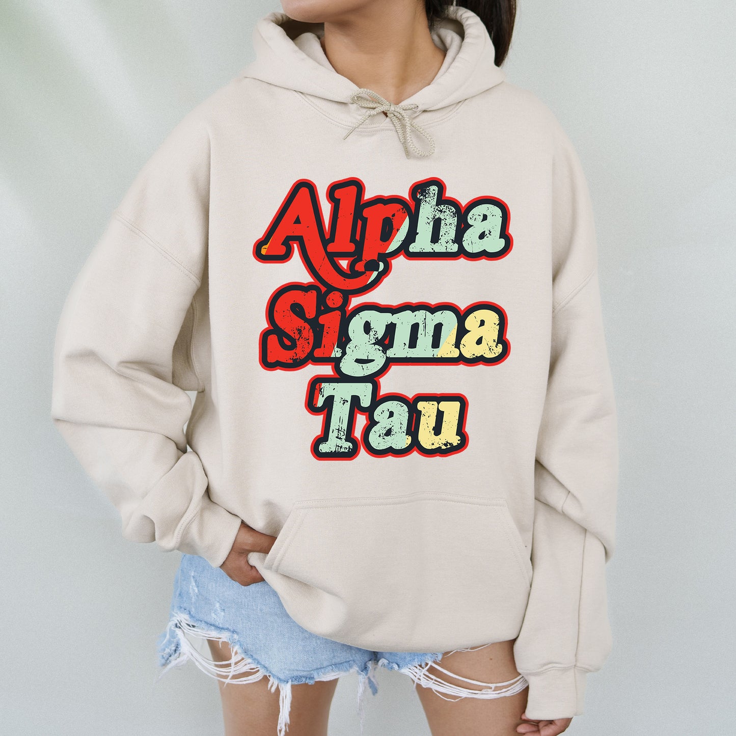 a woman wearing a white sweatshirt with the words aloha stigma tau on it